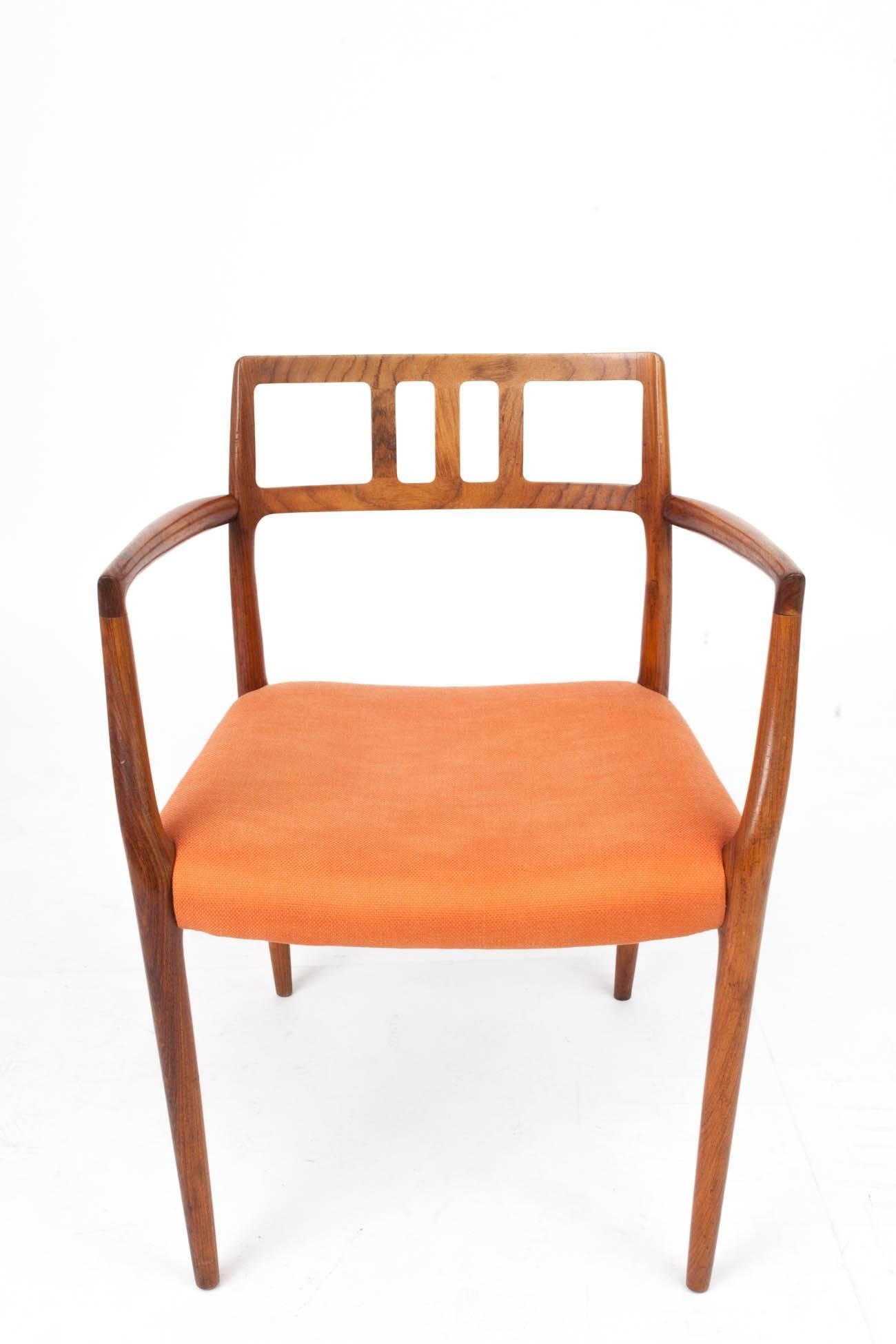 Niels Otto Møller (1922–1988)
Elegant Scandinavian Modern side chair by Niels Otto Møller with sinuous arms, tapered legs, and a comfortable, delicately curving back graced with a Bauhaus-inflected geometry. In teak with orange cotton upholstery.