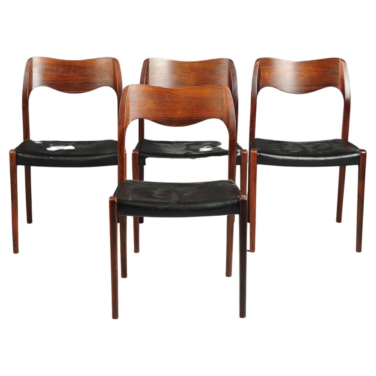 Pictured is a set of four dining chairs designed by Niels Otto Moller in 1951 and made by JL Moller before 1969, as indicated by the round disc label. This listing includes the table pictured. 

Original black leather is in fair condition showing