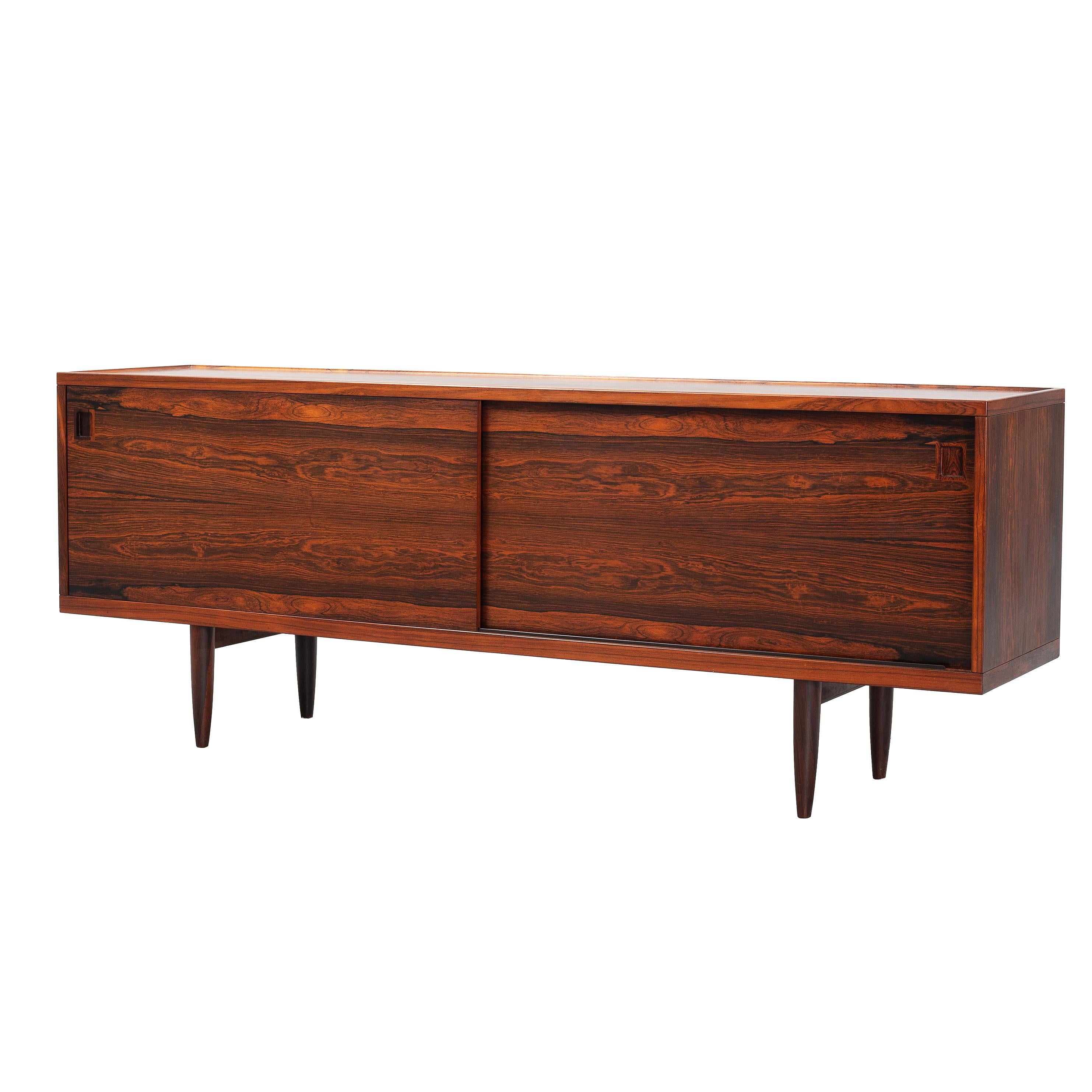 Rare and gorgeous Danish sideboard  Model 20 by Niels Otto Moller for J.L. Mollers in rosewood 1960.
Clean modern design with 2 sliding doors, shelves and 4 drawers inside.
Adjustable shelves. Nice detailed wood grain.
Slight traces of use. Rare