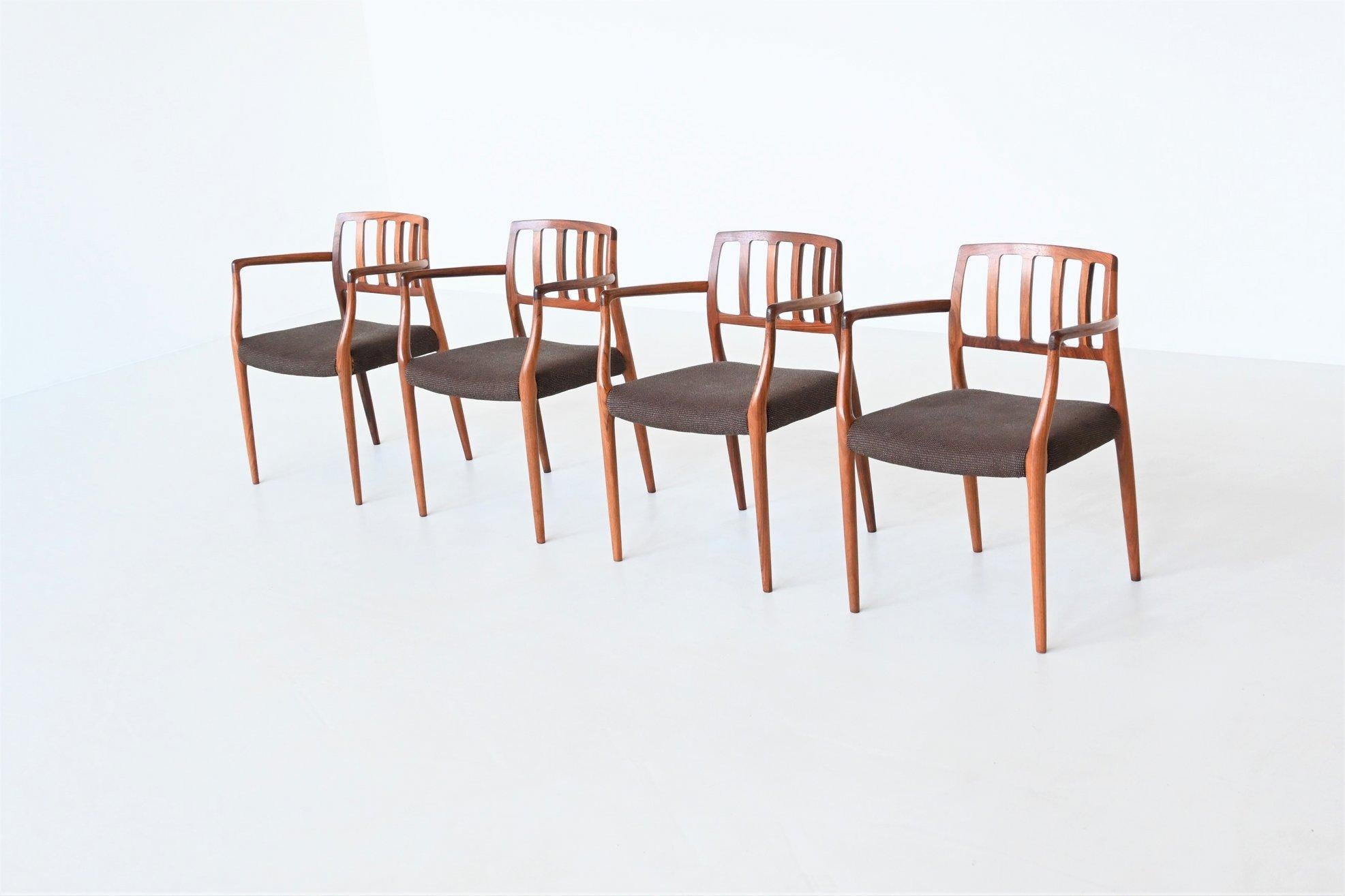 Beautiful shaped and rare set of four armchairs model 66 designed by Niels Otto Møller and manufactured by J.L. Møller Mobelfabrik, Denmark 1974. These sculptural dining chairs are made of solid amazingly grained rosewood and the seats are