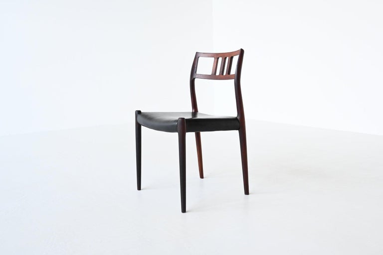 Beautiful shaped dining chair model 79 designed by Niels Otto Møller and manufactured by J.L. Møller Mobelfabrik, Denmark 1960. It is made of solid rosewood and the seat is upholstered with original black leather. This well-crafted chair is still in