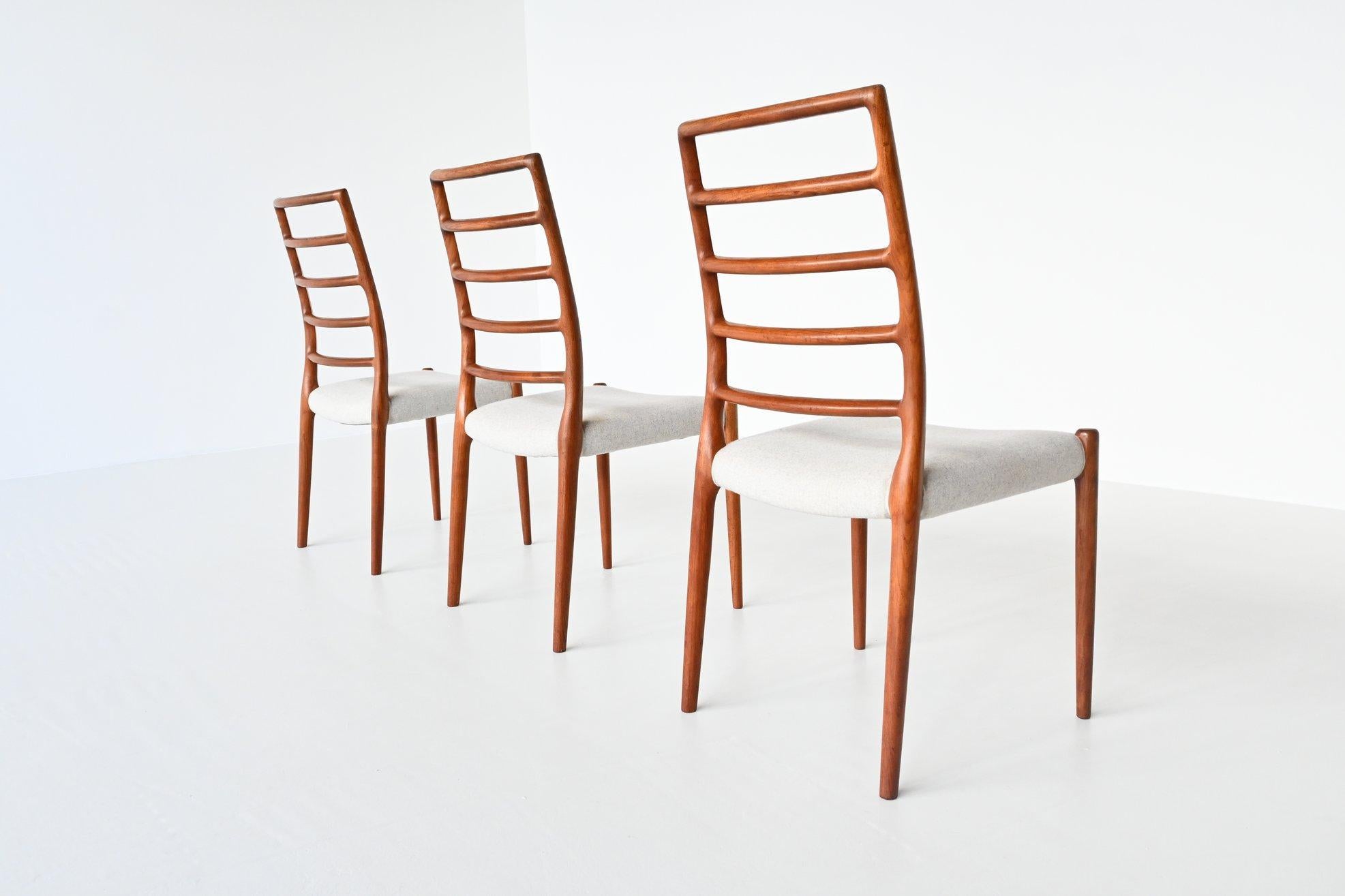 Beautiful set of three dining chairs model 82 designed by Niels Otto Moller and manufactured by J.L. Møller Mobelfabrik, Denmark, 1960. These chairs are made of solid teak wood and are upholstered with cream white Divina Melange fabric of Kvadrat.