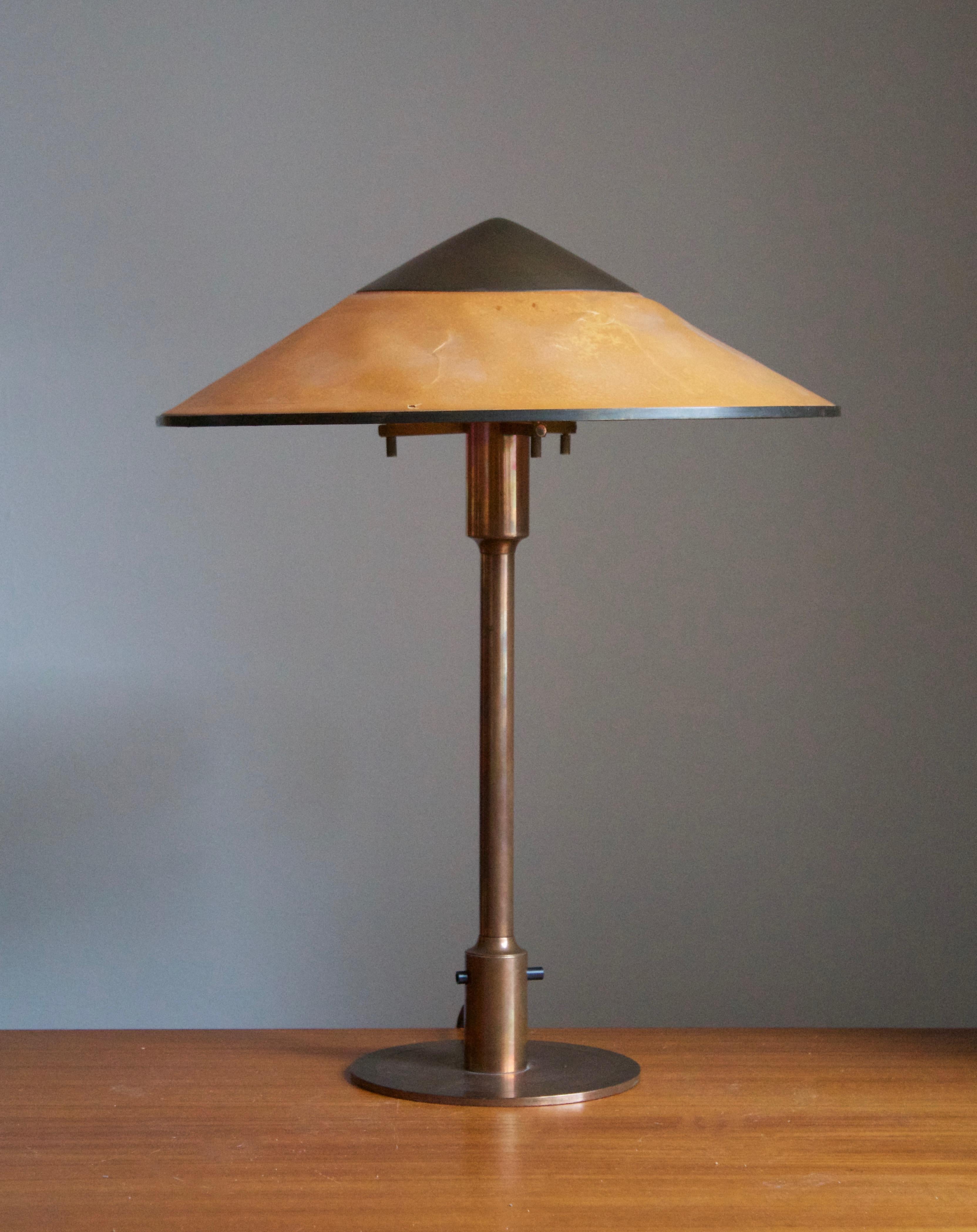 A rare and early table lamp / desk light. Designed by Niels Rasmussen Thykier, Denmark, 1930s. Features a break-through switch typical to early production examples.

In patinated copper and waxed paper screen.

  