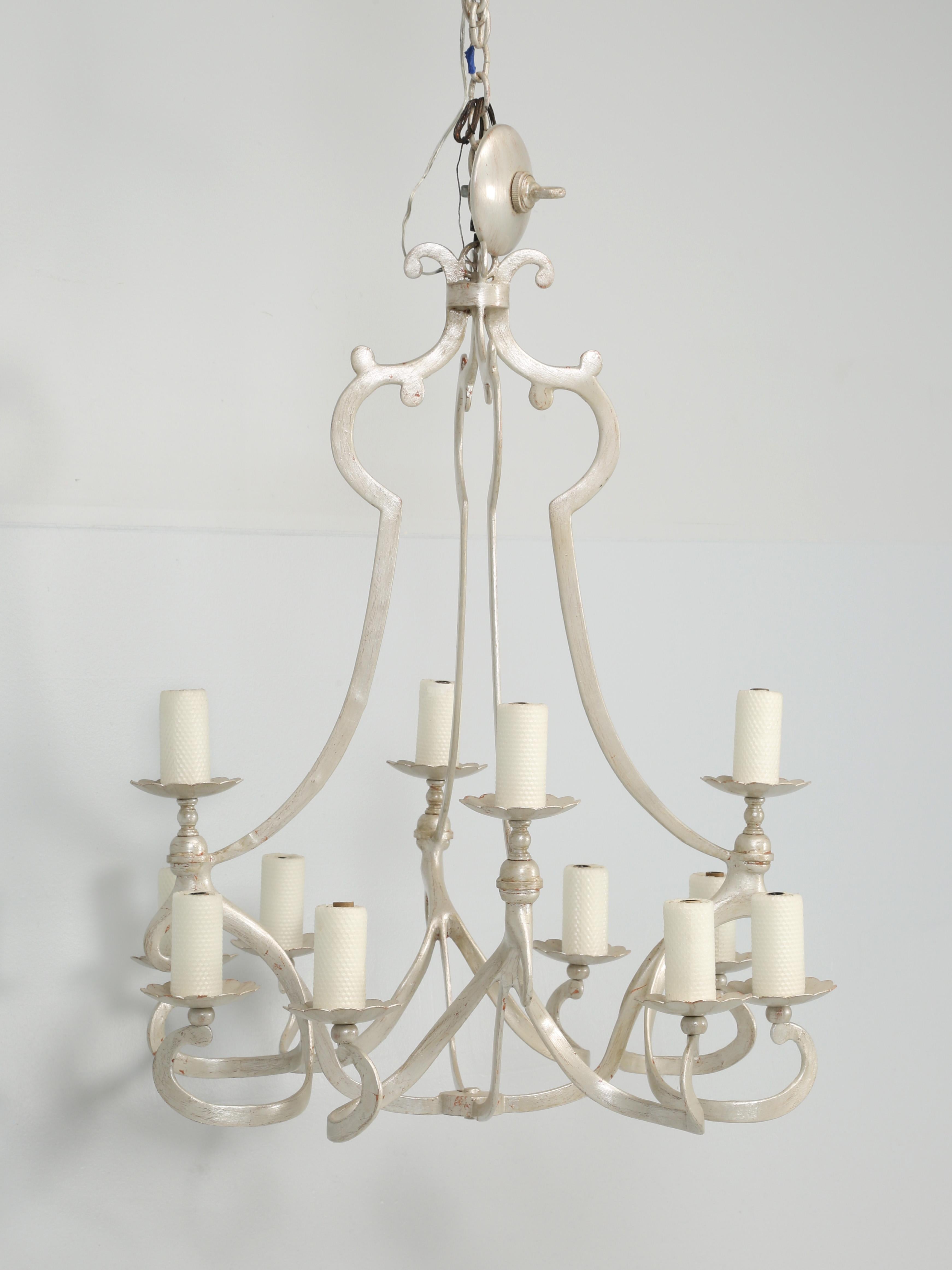 This chandelier was made by the Niermann Weeks Company and is called their crevecoeur chandelier finished in their Veronese Silver silver leaf. The Niermann Weeks website states that it is their interruption of an antique chandelier with many