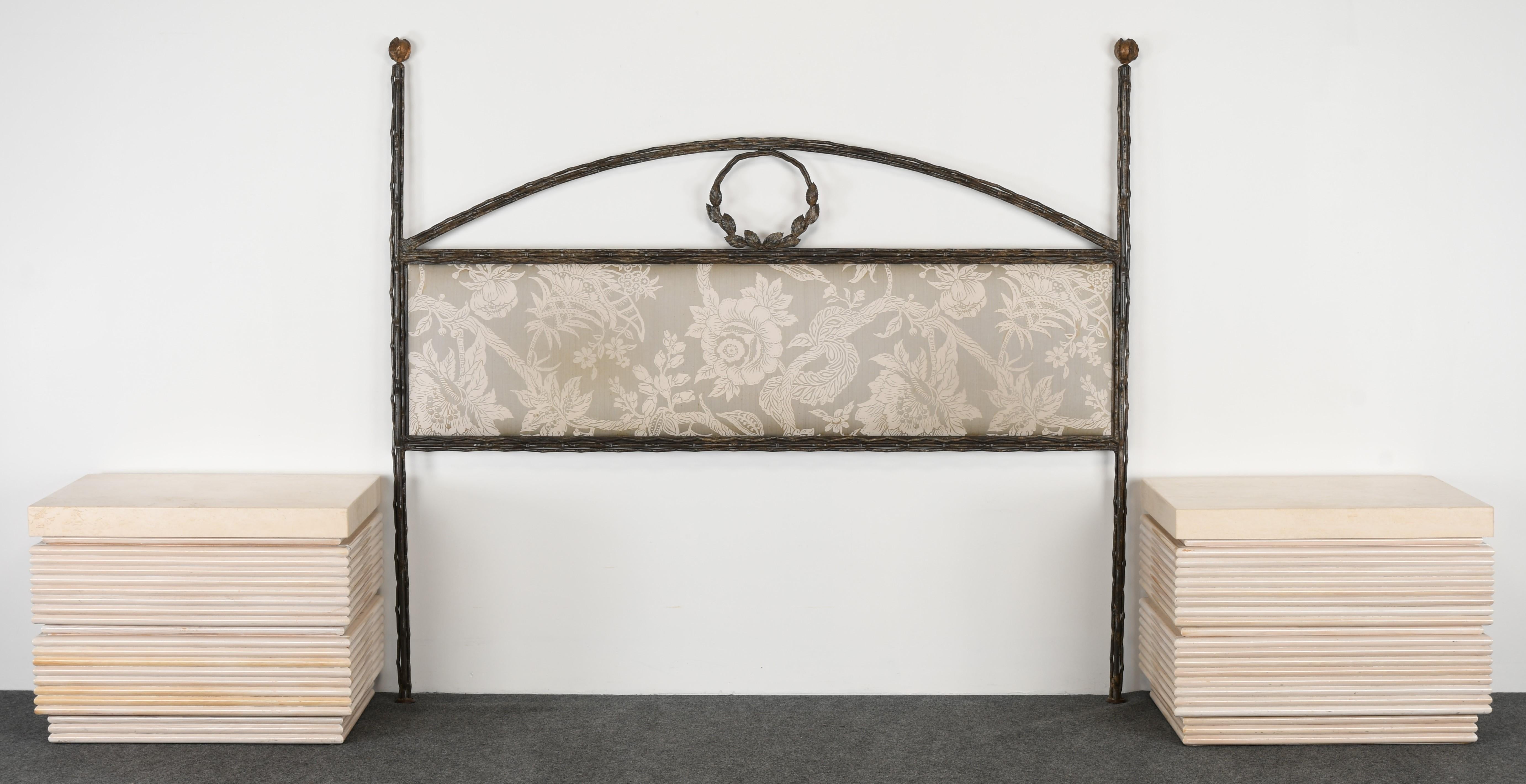 A decorative queen size Niermann Weeks style handwrought Iron Headboard. The headboard has a decorative laurel wreath motif. Structurally sound and in very good condition. New upholstery is necessary. Nightstands are available in another