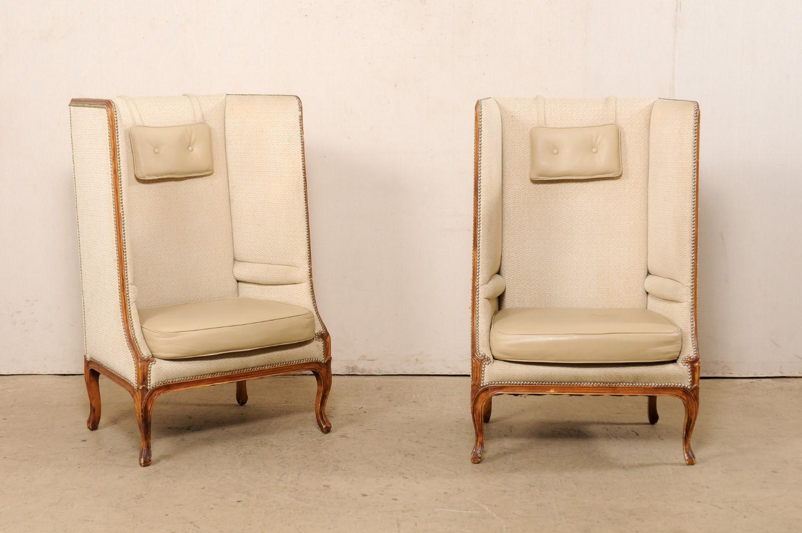 A fabulous pair of high wingback upholstered chairs, by American creator/manufacturer Niermann Weeks, created for (and originally from) the Ritz Carlton in Palm Beach, Florida. This pair of chairs each have tall rectangular-shaped backs (over 4 feet
