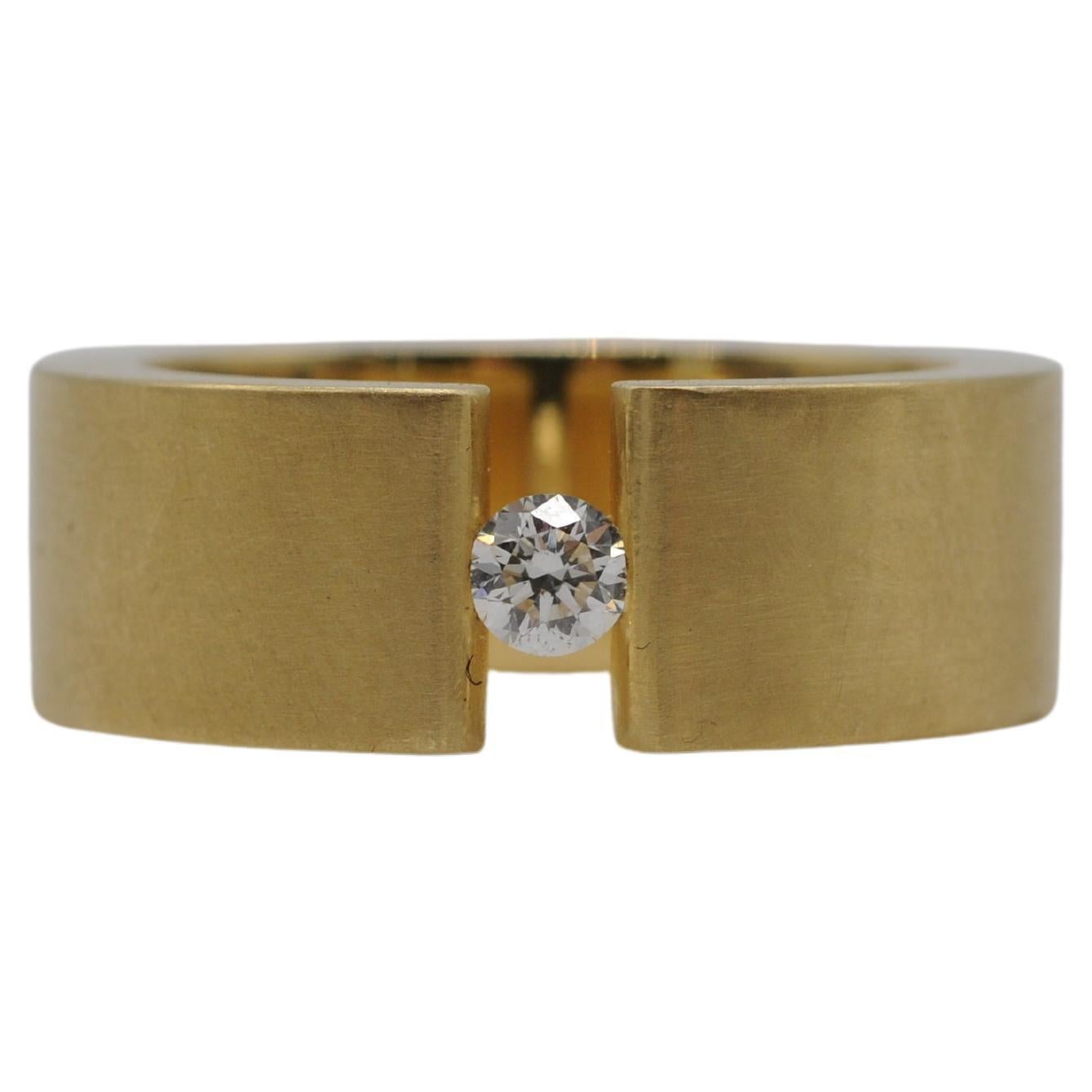 Aesthetic Movement Niessing tension ring in 18k yellow gold with a brilliant For Sale