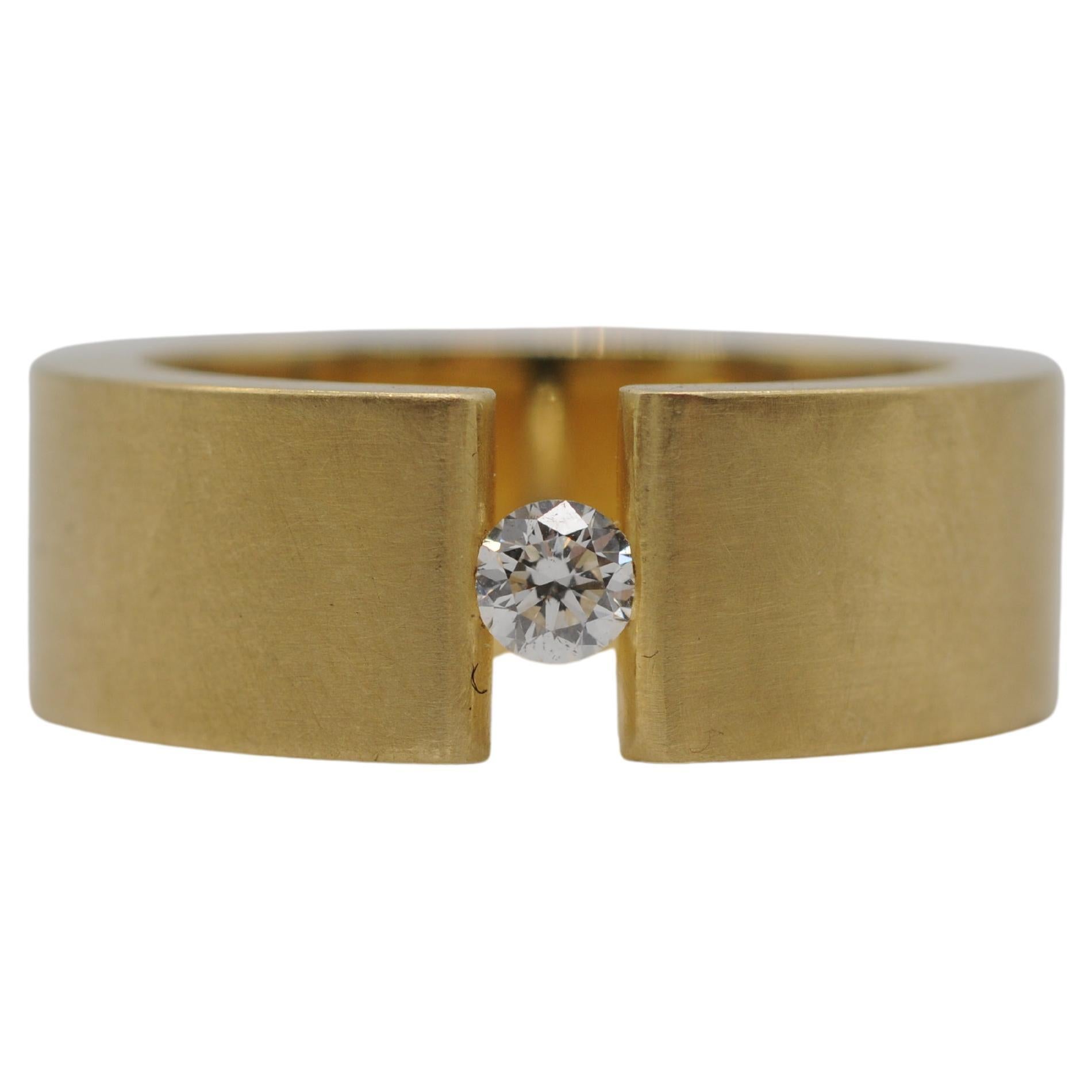 Aesthetic Movement Niessing tension ring in 18k yellow gold with a brilliant For Sale
