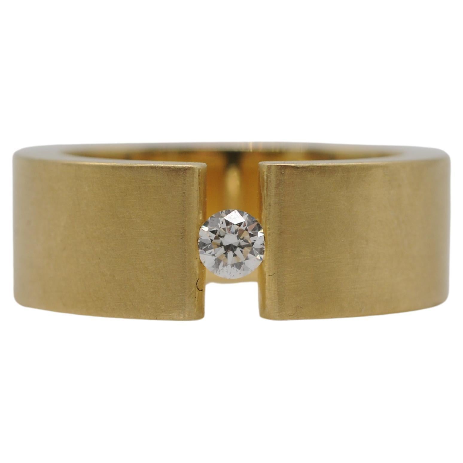 Women's or Men's Niessing tension ring in 18k yellow gold with a brilliant For Sale