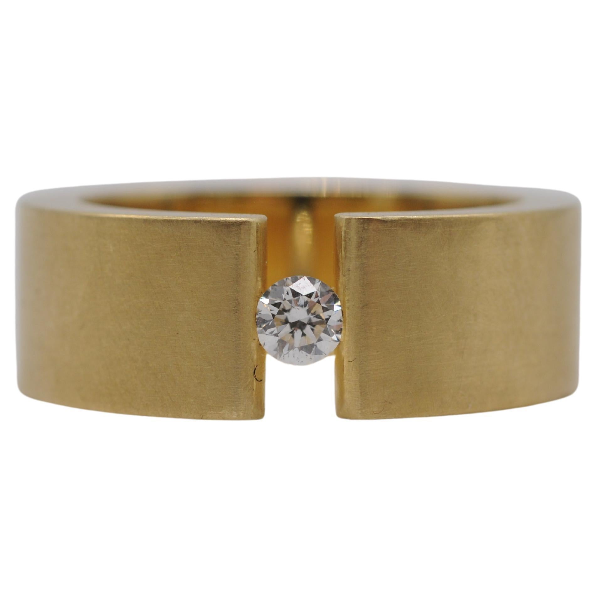 Niessing tension ring in 18k yellow gold with a brilliant For Sale