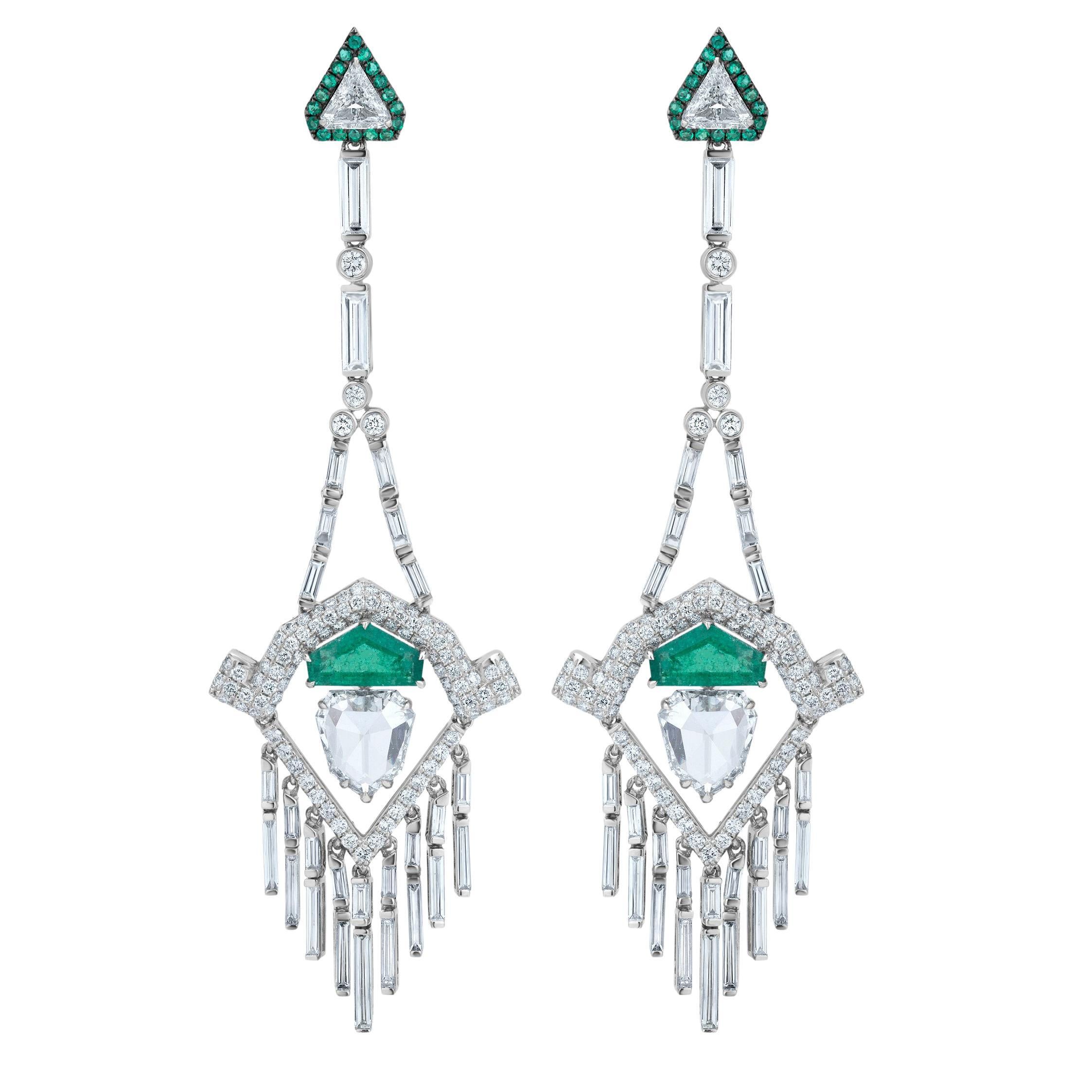 This Nigaam, Chandelier earring in 18k White Gold  is a fine amalgamation of Emerald and Diamond. The triangular surmount has the finesse of triangle-cut diamond surrounded with round-cut emeralds that form a rim around it. The bail is accentuated