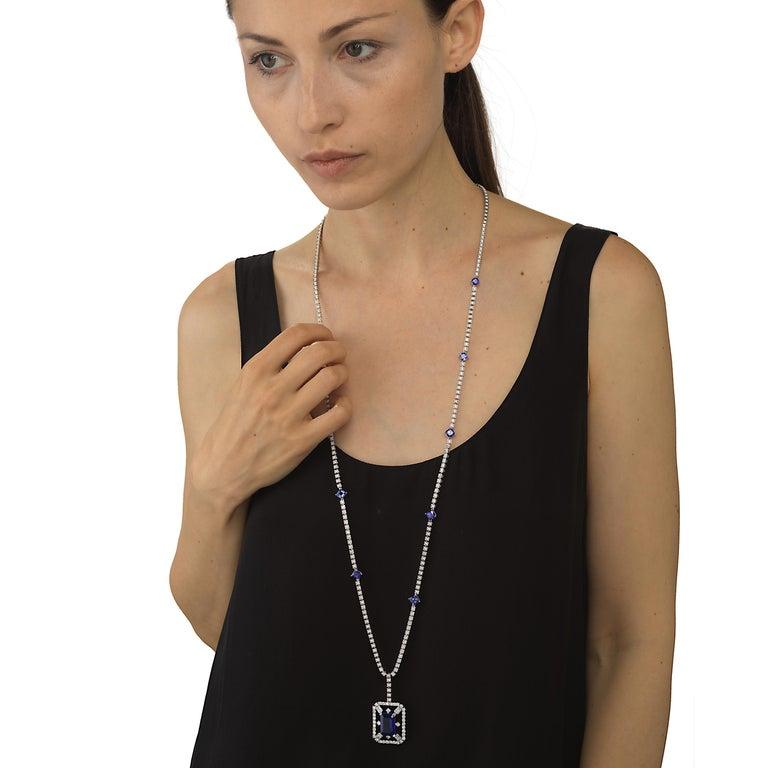 This 36 inch pendant necklace by Nigaam has a 11 carat octagon tanzanite at its center in diamond frame . The 18k white gold necklace is further embellished by cushion cut tanzanites on the chain along with round diamonds. This necklace comes with a