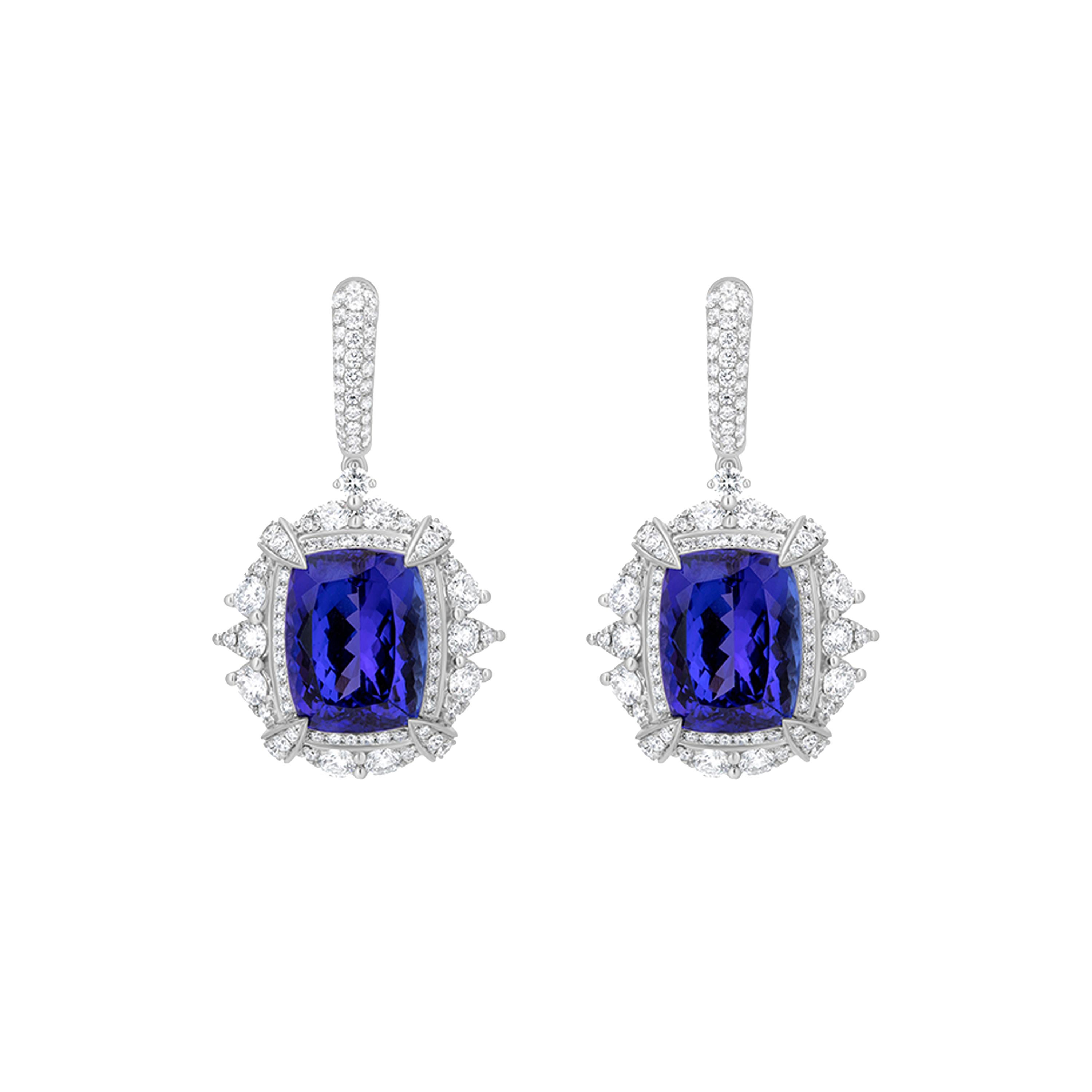 This Nigaam 30.93 Ct. T.W. Tanzanite and Diamond Dangle Earrings in 18K White Gold features 25.95 cts. Tanzanite drops held by diamond claws. The Tanzanite drops are enclosed in a diamond halos which are further accentuated by pear diamonds.  The