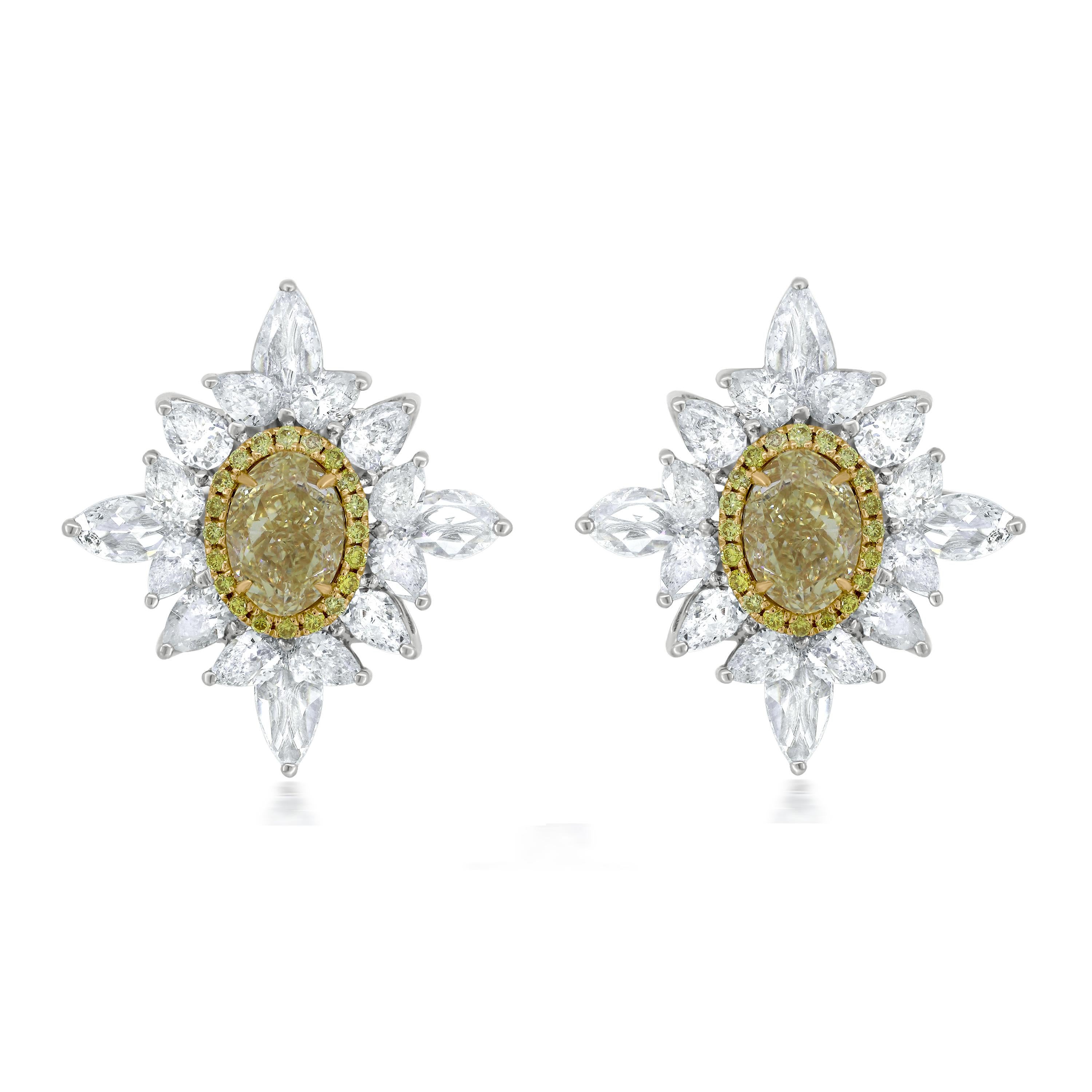 These Nigaam 18k white and yellow gold diamond earrings look elegant with 1.23 carats oval-shaped yellow diamond centerpiece. The center yellow diamonds are gracefully surrounded by pear-shaped white diamonds that add shine and sparkle to your