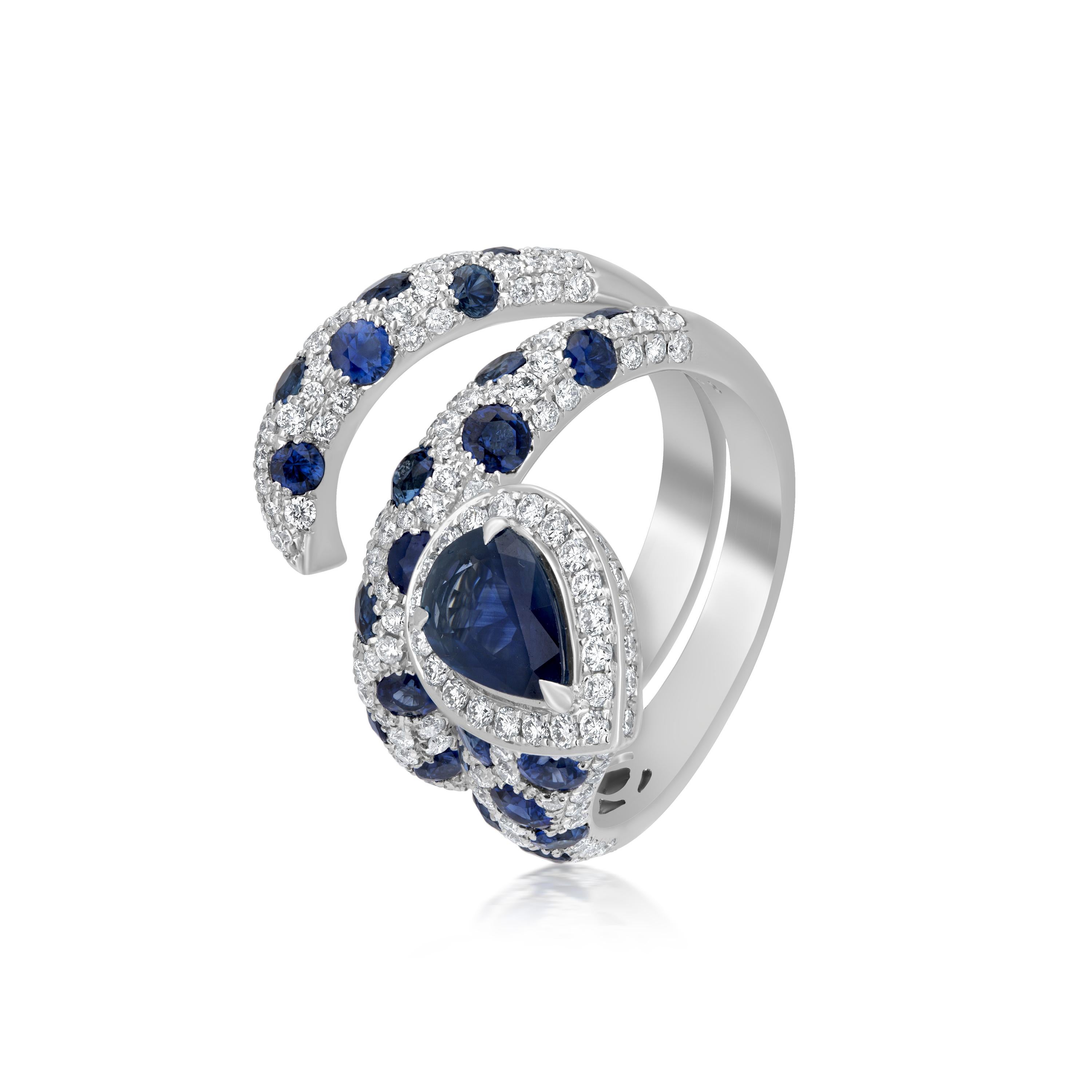 Twirl with this swirl ring in a gorgeous saree on your engagement day. Crafted by Nigaam on an 18K White Gold body, this ring has round full-cut diamonds and round-cut and pear-cut blue sapphires in a lovely pattern that is unmatched, and rare to