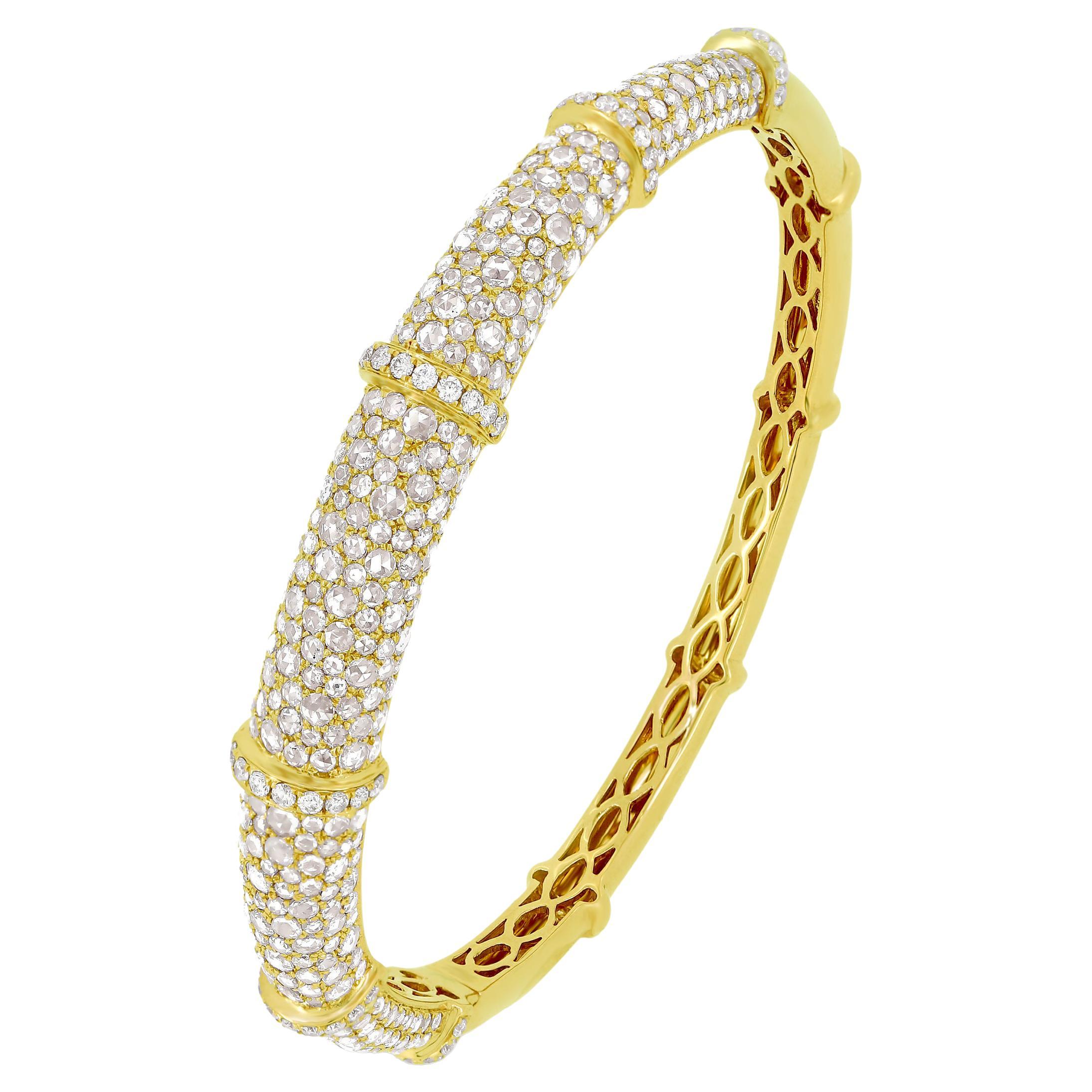 This beautiful bangle bracelet is made by Nigaam in 18 karat yellow gold and 5.21 carat diamond. The stunning bangle is pave set with round-brilliant cut diamonds on its top front and lattice designs accentuating its inner back. The bangle bracelet