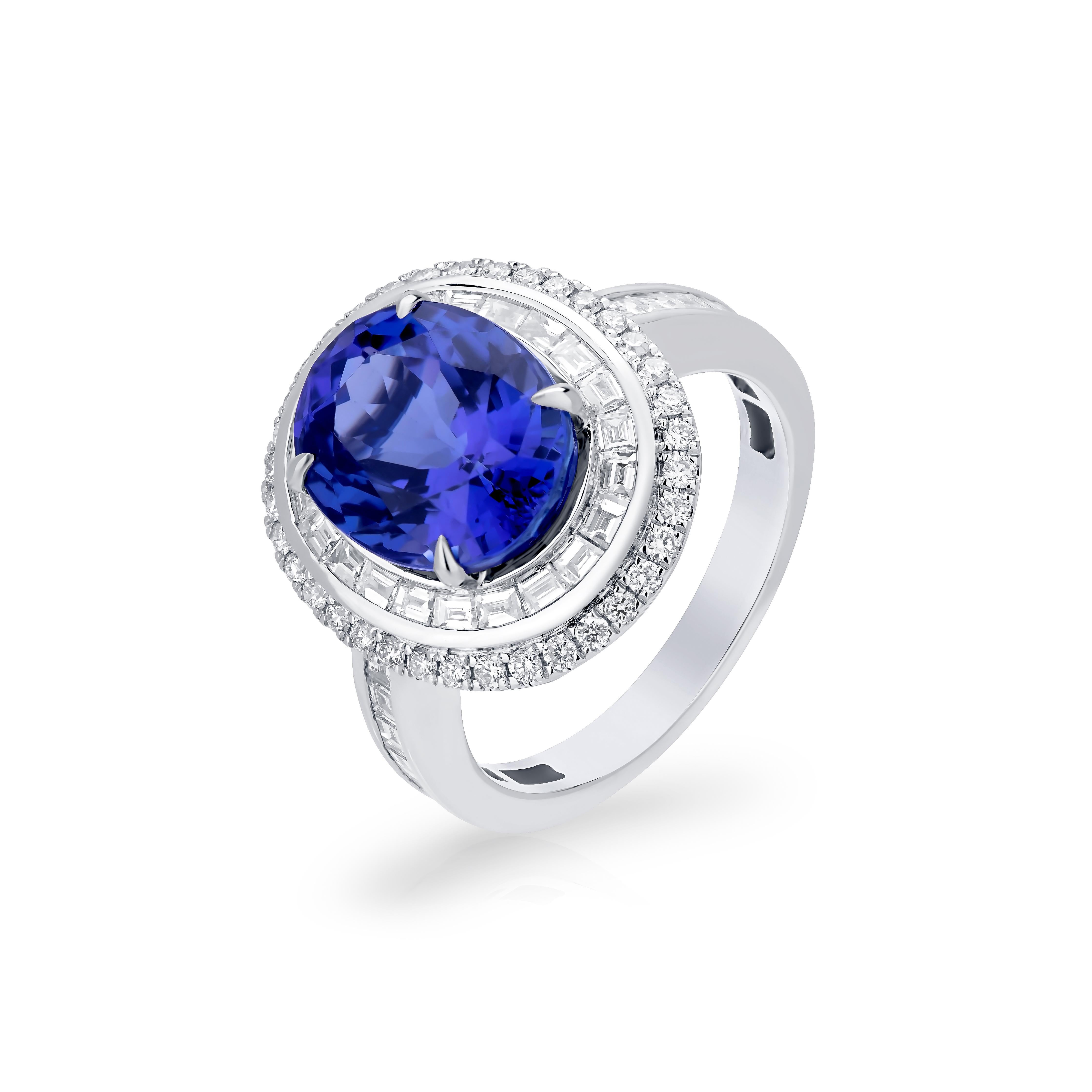 This stunning Nigaam ring crafted in 18K White Gold is a sublime and classy piece. The 5.41 Cts Tanzanite in the center of the ring creates a focal point for this beautiful ring. Surrounded by 1.25 Cts round and baguette-shaped full-cut diamonds