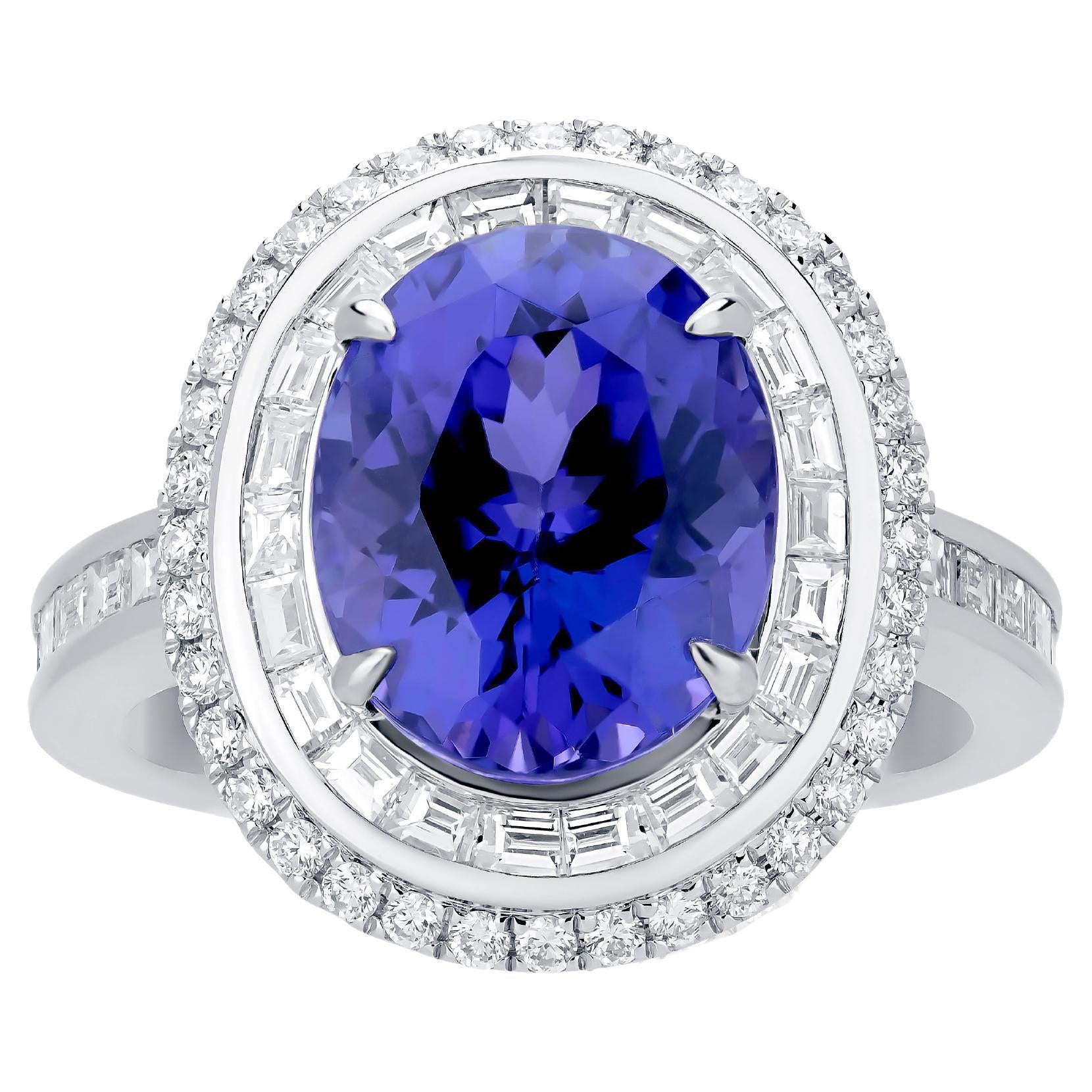 Nigaam 5.41cts. Oval Tanzanite and 1.25Cts. Diamond Cluster Ring in 18k Gold For Sale