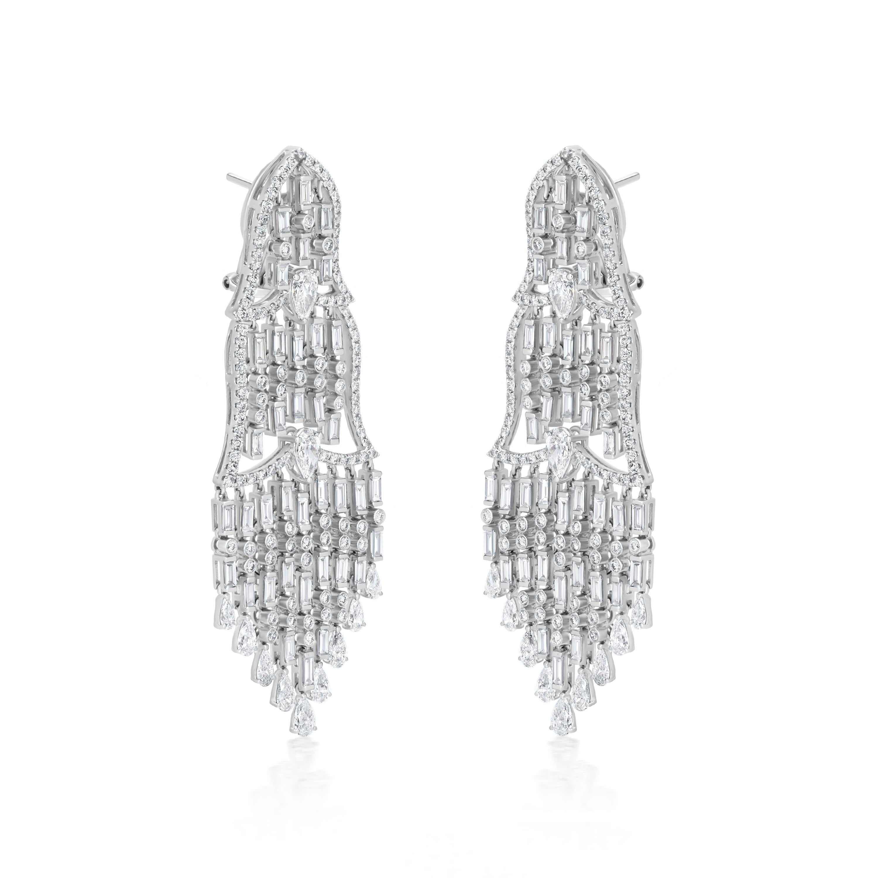 Our Nigaam 8.13 Cttw. Diamond Chandelier Earrings are the epitome of luxury and elegance. These earrings are crafted from the finest 18K white gold and feature a double diamond crown design on the top, with multiple diamond strands hanging elegantly