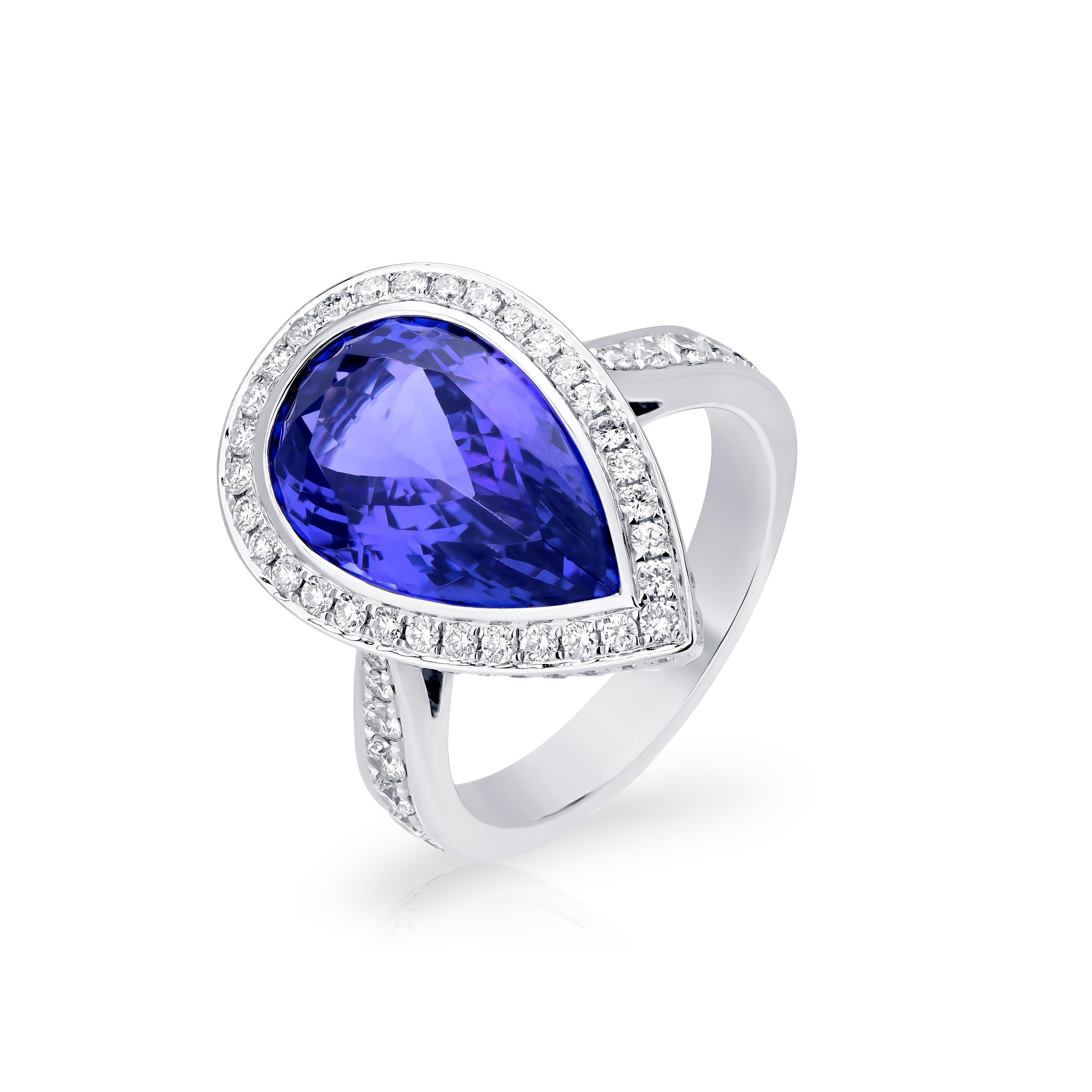 Bright and beautiful, this stunning ring is crafted in 18K White Gold by Nigaam. With a pear-shaped 7.26 Cts Tanzanite set in the center, this ring has been embedded with 1.03 Cts round full-cut diamonds around the center gemstone as well as on the