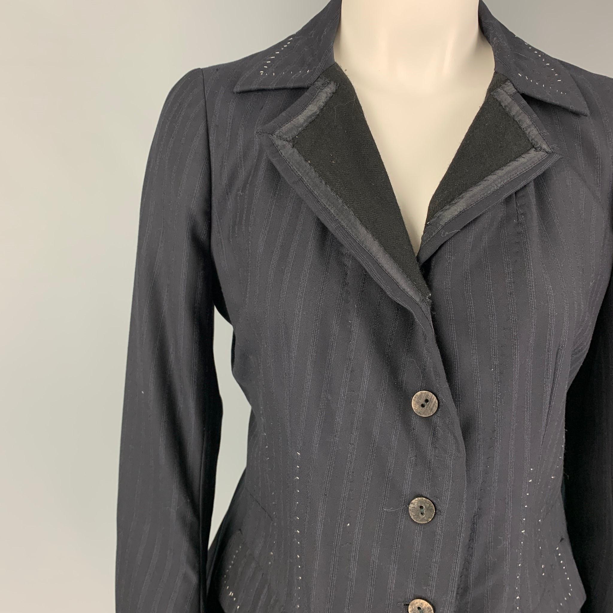 NIGEL PRESTON jacket comes in a navy stripe wool / cotton featuring a notch lapel, contrast stitching, inner strap detail, flap pockets, ruffled back, and a buttoned closure. 

Very Good Pre-Owned Condition. Light wear. As-is.
Marked: