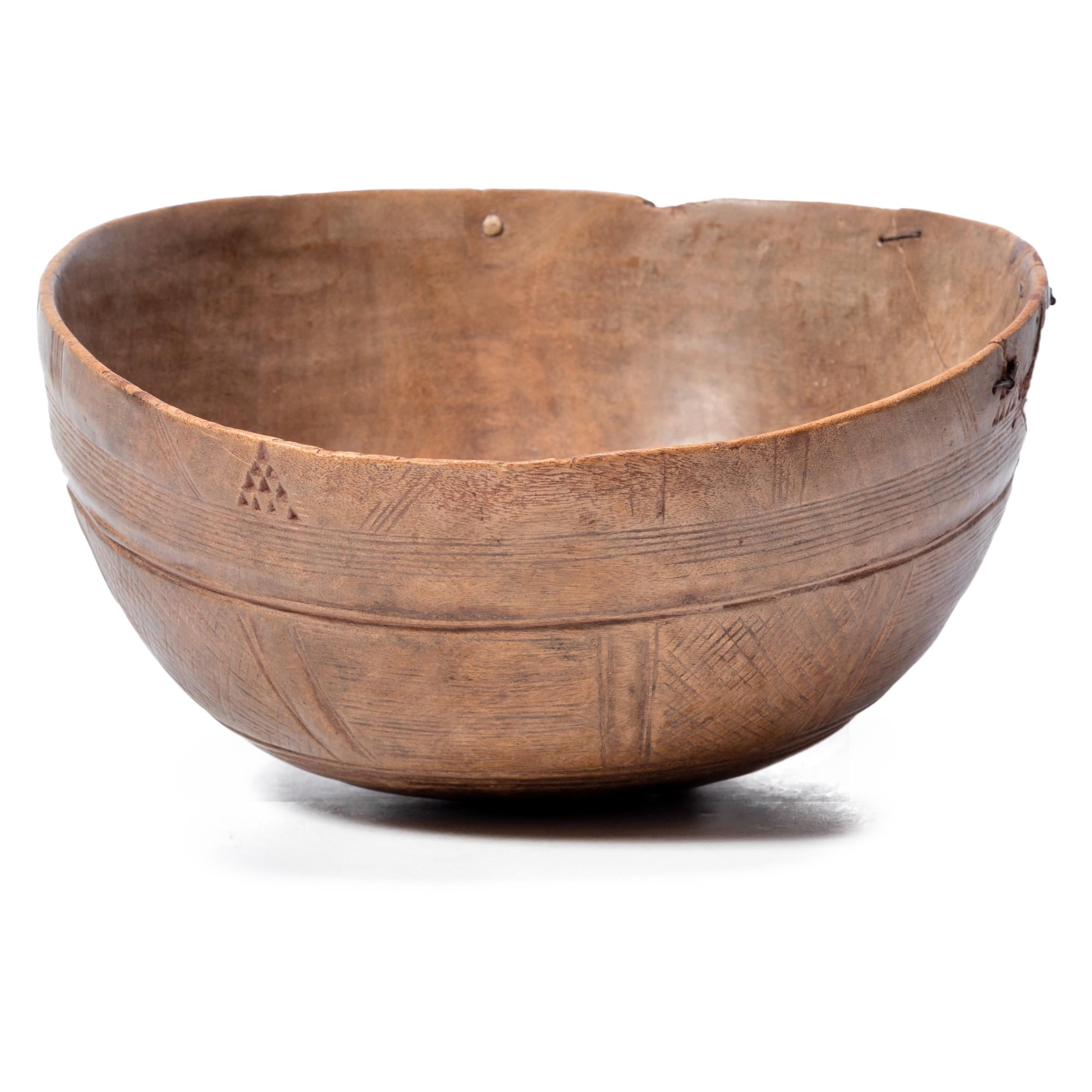 This carefully incised wooden bowl originally belonged to a Fulani family, a Muslim culture scattered throughout West Africa. Because the Fulani are frequently nomadic, they rely on neighboring cultures for the production of many of their objects.