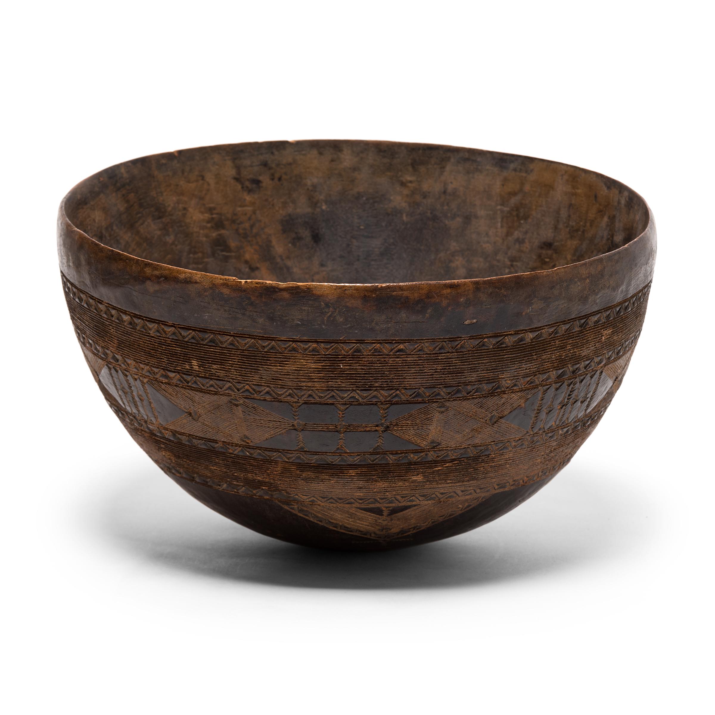 This carefully incised wooden bowl originally belonged to a Fulani family, a Muslim culture scattered throughout West Africa. Because the Fulani are frequently nomadic, they rely on neighboring cultures for the production of many of their objects.