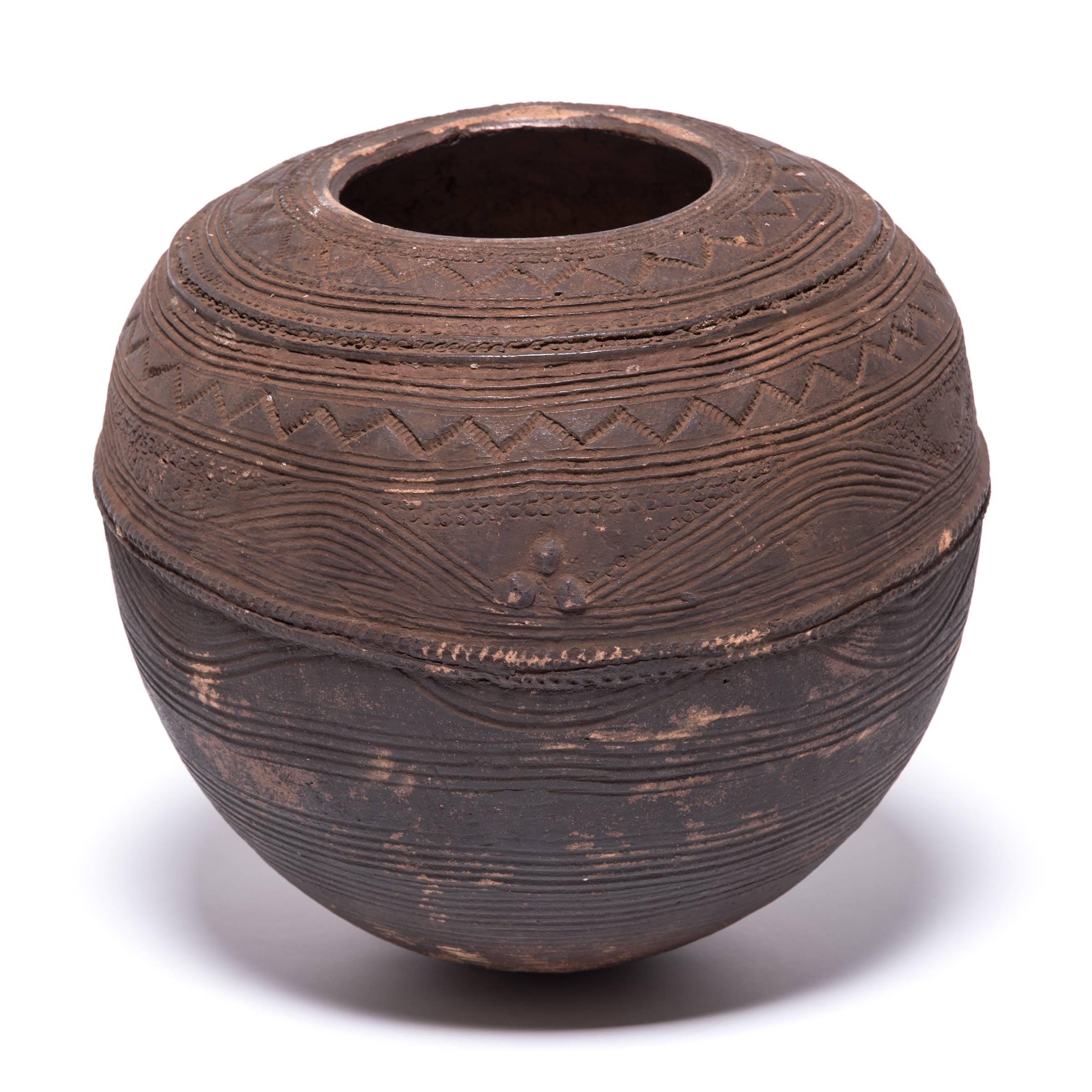 The Nupe people of Nigeria were touted as some of the finest ceramicists in Africa. Everyday objects, like this water vessel received detailed attention. The vessel's varied textures are an integral part of its utilitarian design. The patterns and
