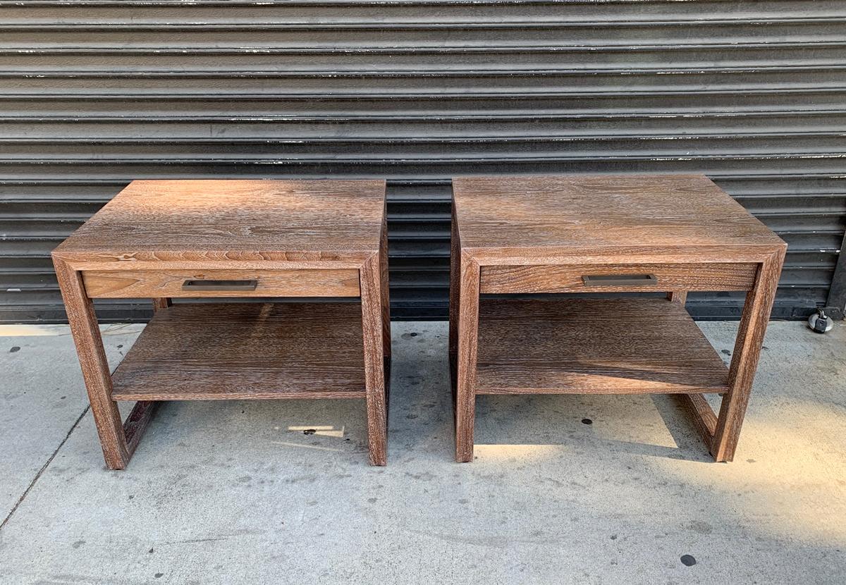 Beautiful pair of nightstands designed and manufactured in the US by Altura Furniture and made in ceruzed walnut wood with bronze hardware.

The clean modern form of the Arris side table is enhanced by its focused attention to details, most