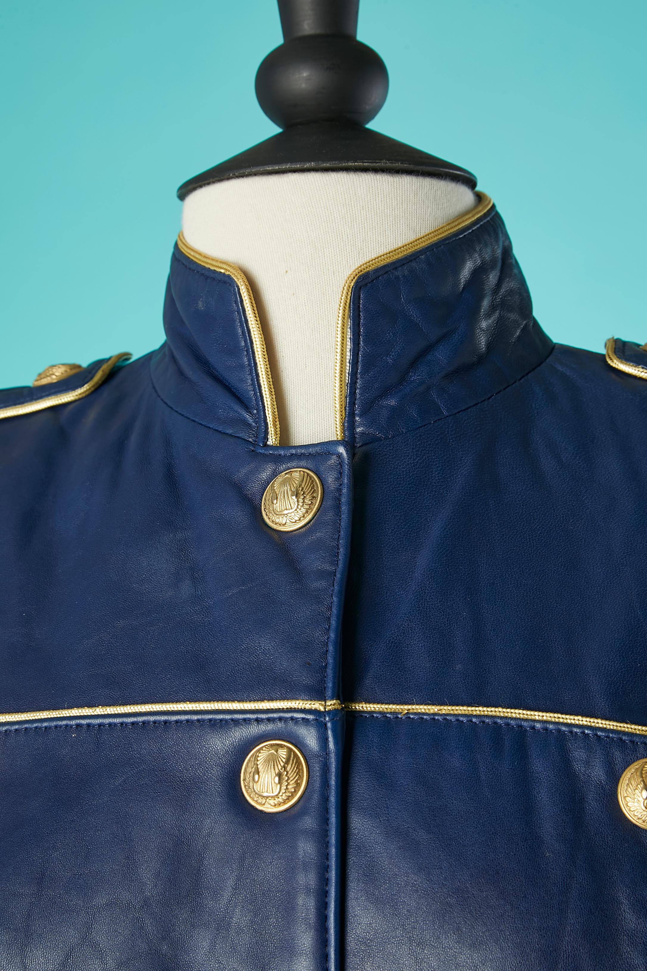 Night blue officier style leather dress. Rayon lining. Large shoulder-pads. Gold metal 