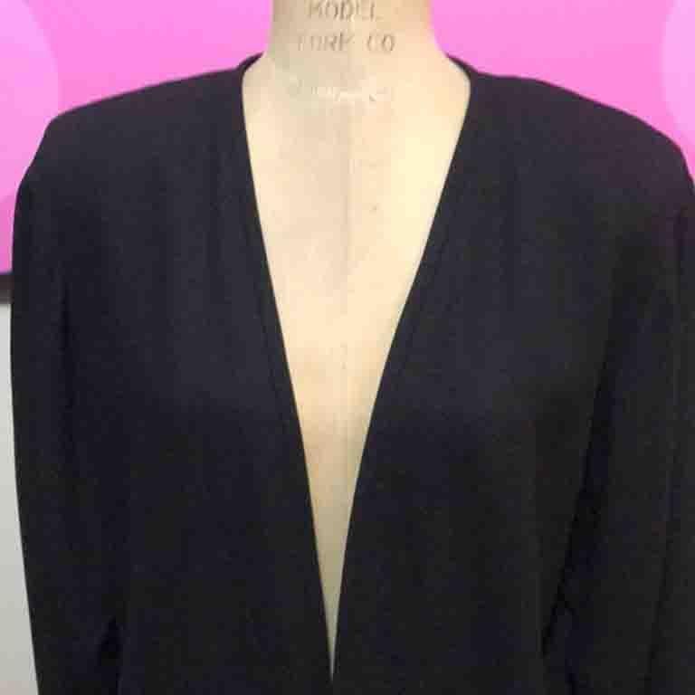 Special occasion dressing is easy wearing this classic black jacket. Shoulder pads. Crepe fabric. Vintage wonder!

Size 4 - over sized design
Across chest - 20 1/2 in.
Across waist - 19 1/2 in.
Shoulder to hem - 24 1/2 in.
Shoulder to cuff - 24 1/2