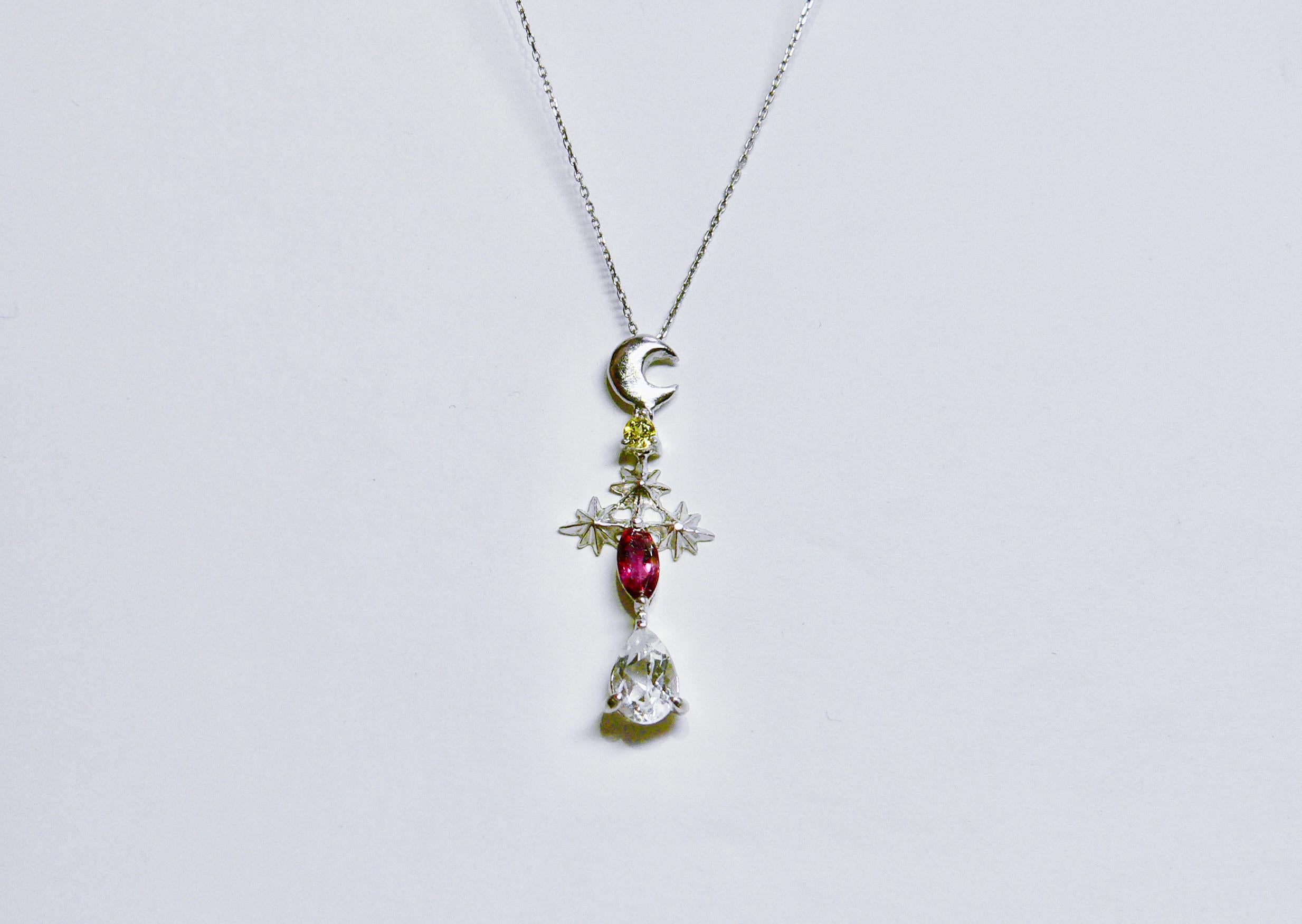 Night sky with crescent moon and stars with some colors.

This necklace is made of rhodium plated Sterling Silver with two colors of Tourmaline (canary yellow tourmaline and pink tourmaline) and colorless Quartz as one of the Night Collection. This