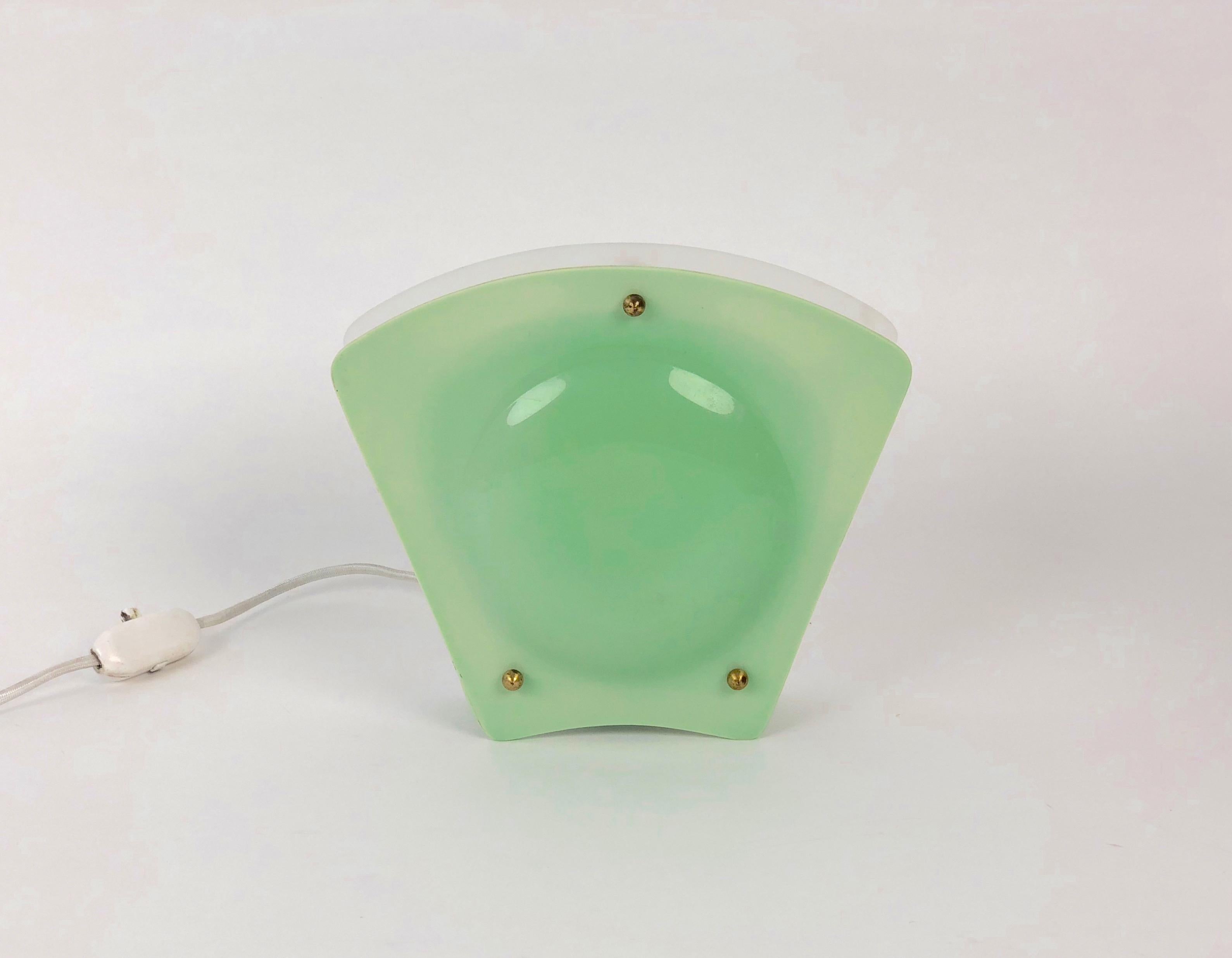 A simple, charming night light from Austria out of the 1950's. The white plastic side is meant to reflect light on the wall and green side is for viewing. The lamp uses a 10 to 15 watt bulb typically found in refrigerators. Matt bulbs give the best