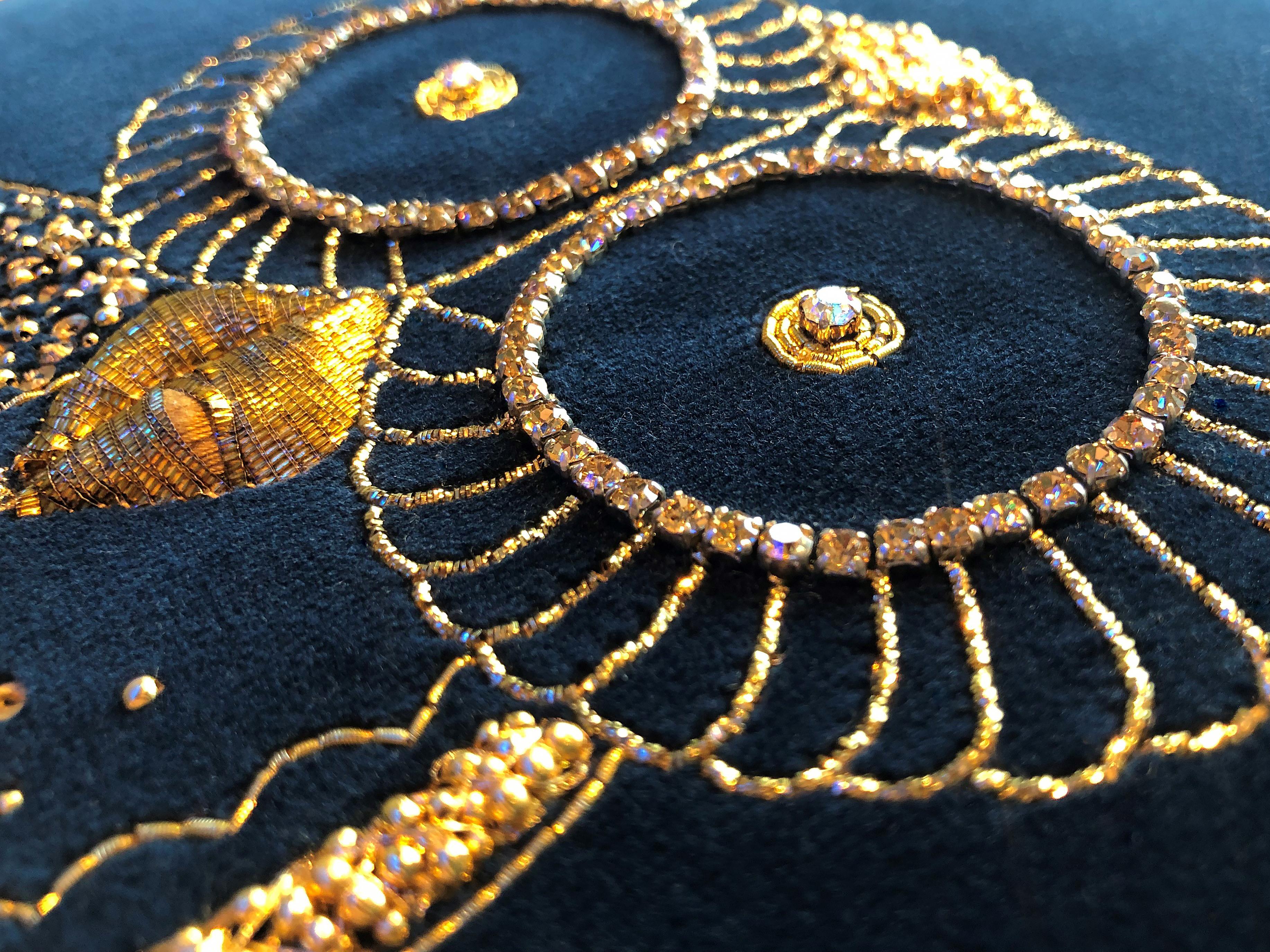 Luxury cushion in deep navy velvet material, featuring handmade embroidery by Lesage in crystals with antique gold thread and gold rope. 

The cushions can be made completely bespoke and perhaps epitomize a movement now to bring back embroidery