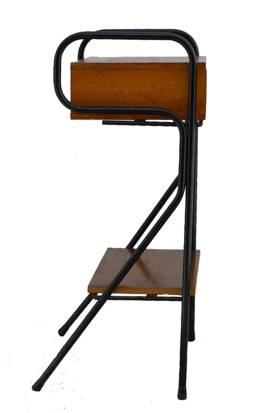Nightstand by Jacques Hitier midcentury circa 1950
Side cabinet bedside table
Black steel legs with oak shelf and drawer
Good vintage condition with signs of age related use and wear
With small marks of use to wood veneer, children’s pencil
