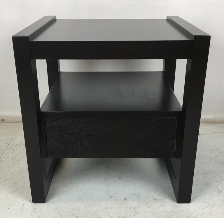Bi-level nightstand or end table with canted front drawer by Paul Laszlo. The table has been freshly refinished in Espresso lacquer.