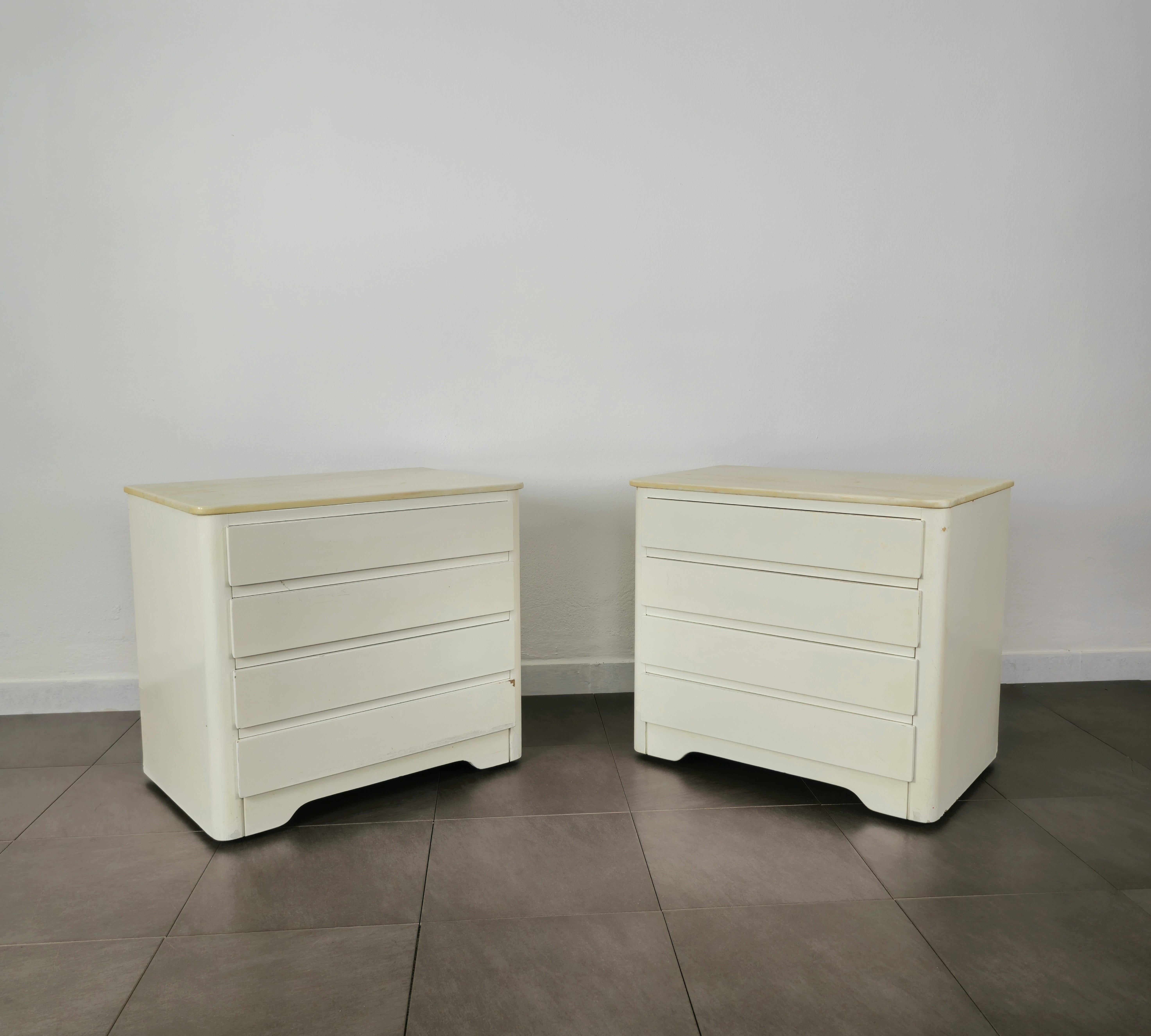 Pair of bedside tables produced in Italy in the 70s.
Each single bedside table that can be directed by wheels was made of white enamelled wood with 4 drawers and a marble top.



Note: We try to offer our customers an excellent service even in