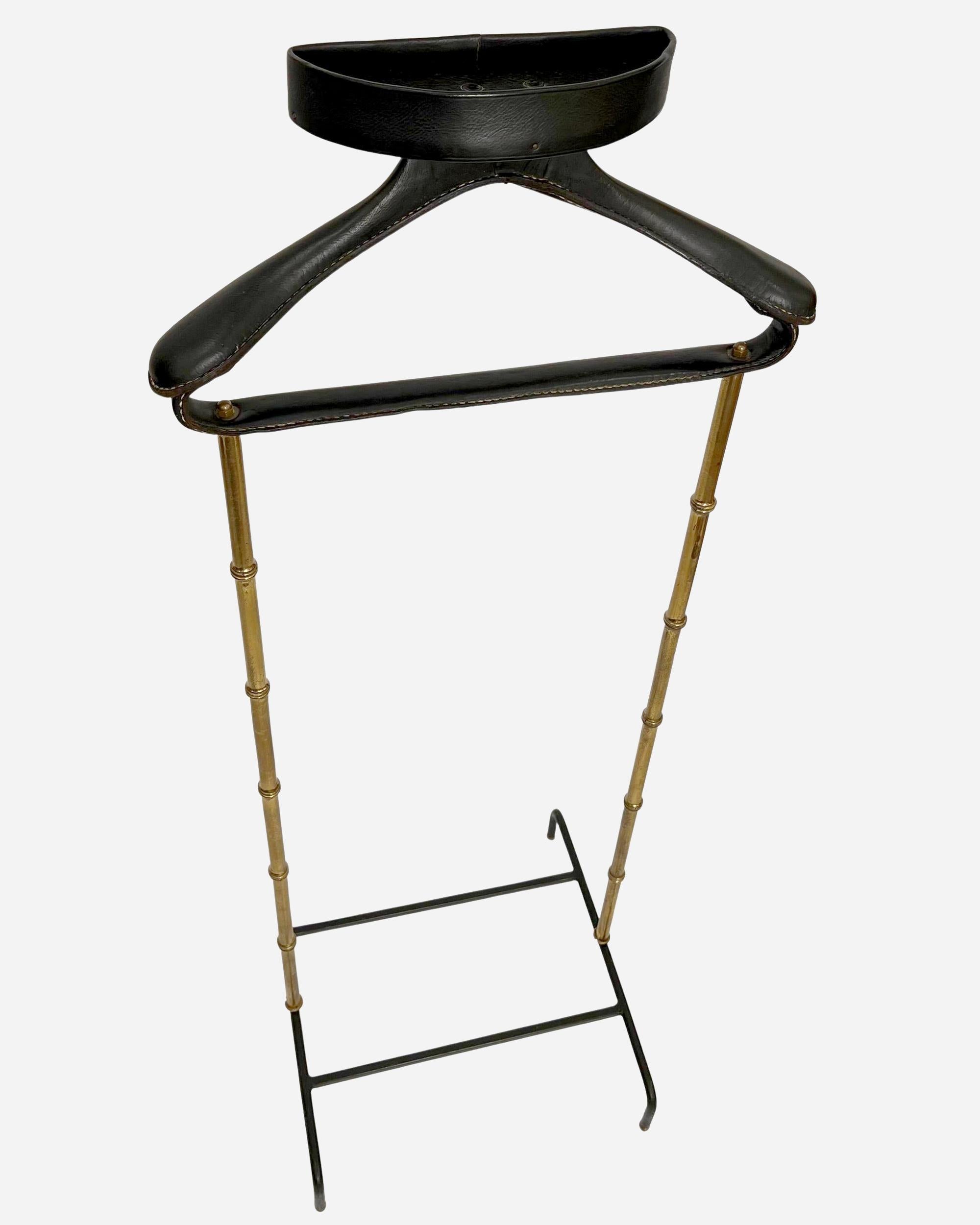 Nightstand with brass structure turned in imitation bamboo, baguier, coat and trouser rack entirely sheathed in black leather with saddle-stitching.
Black lacquered wrought-iron base resting on four spherical brass feet.

Biography

Jacques Adnet,