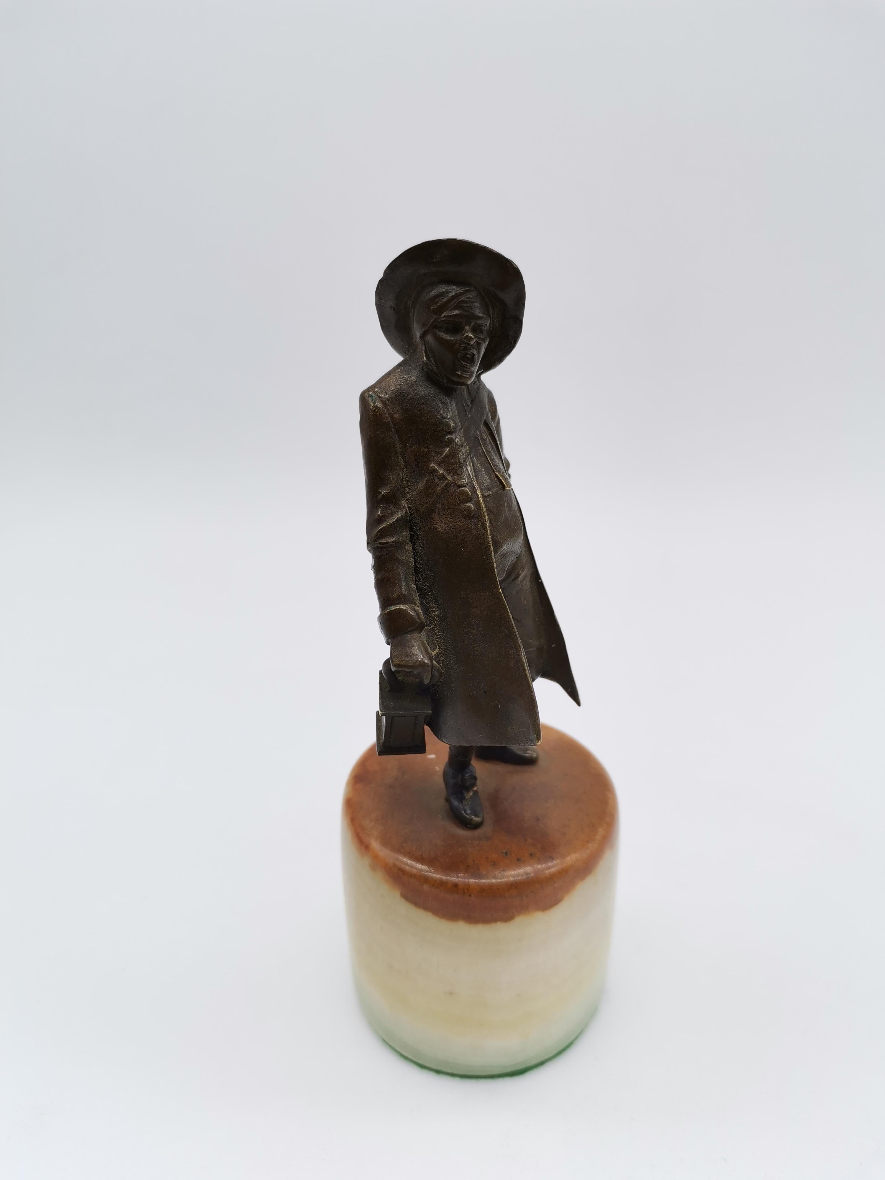 A figurine of a night watchman on a pedestal of marblestone.