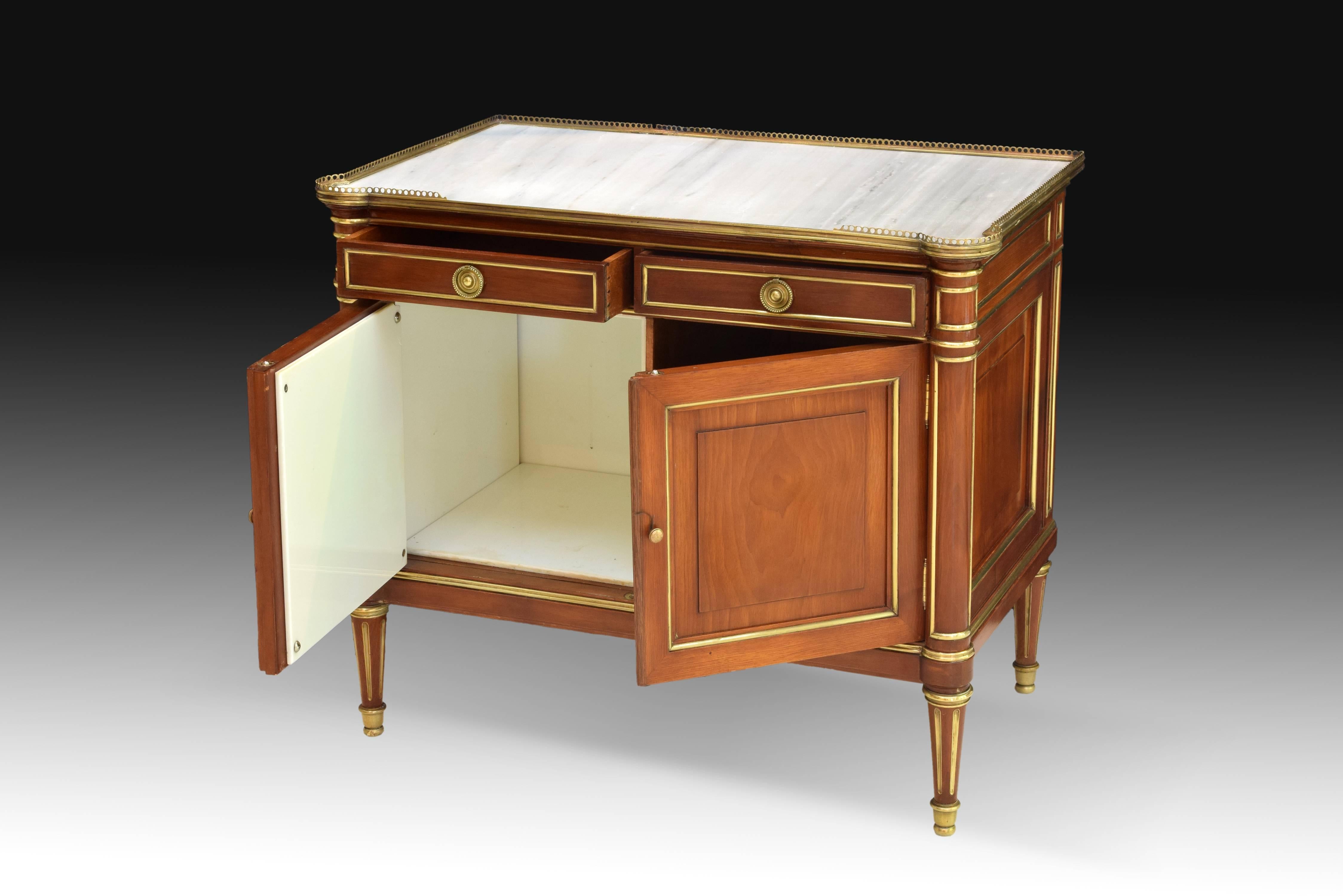 Nightstand shaped and decorated like an French Empire style commode. Raised on four legs in the shape of a ribbed column, it has two doors in the front and two drawers on them, as well as a white upper board enhanced with a Fine open railing. The