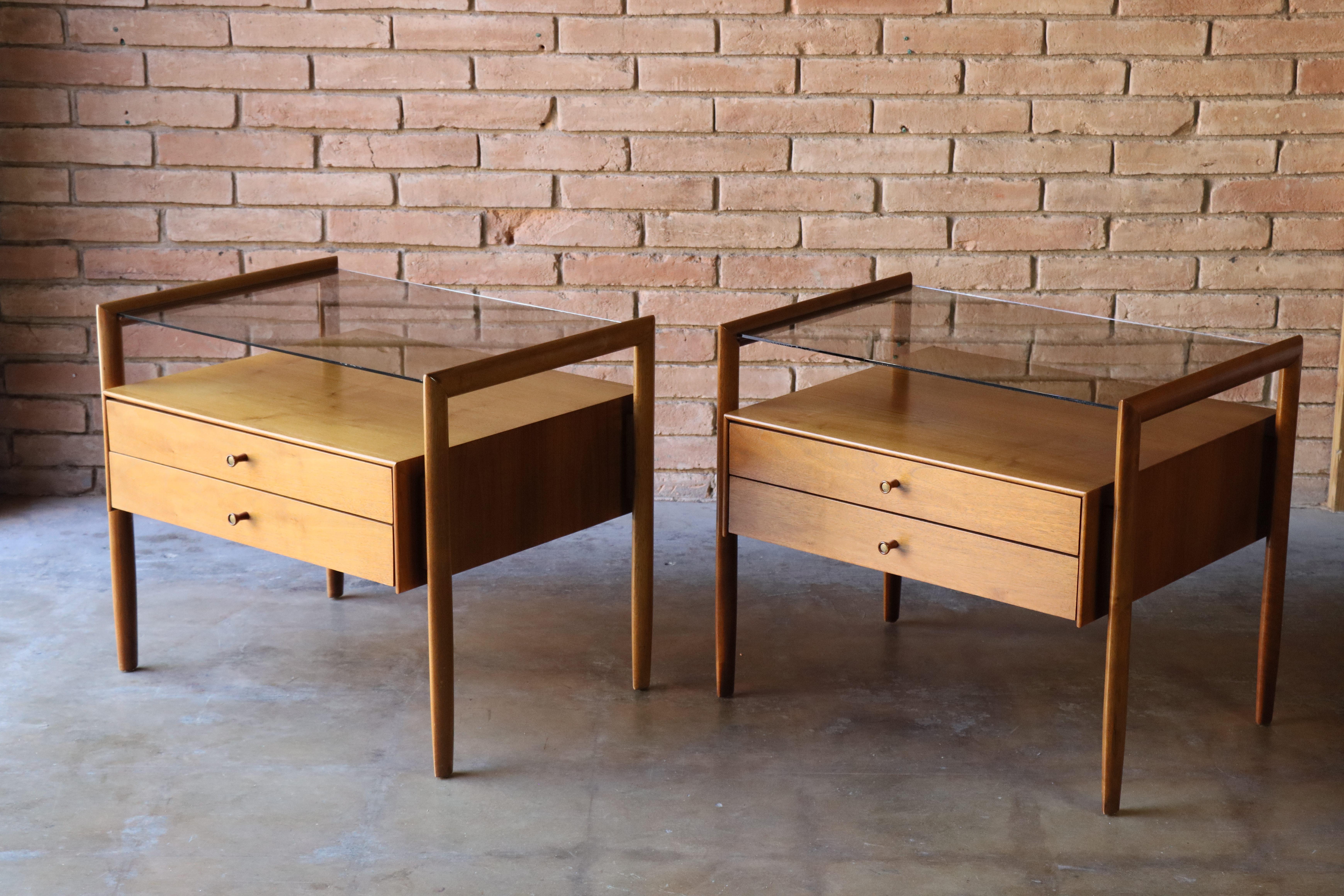 Rare pair of nightstands designed by Barney Flagg for Drexel, c. 1960s. Part of Drexel’s ‘Parallel’ series, these beautiful examples are made from rich walnut and glass tops. The solid walnut frames suspend the floating cabinets and glass tops