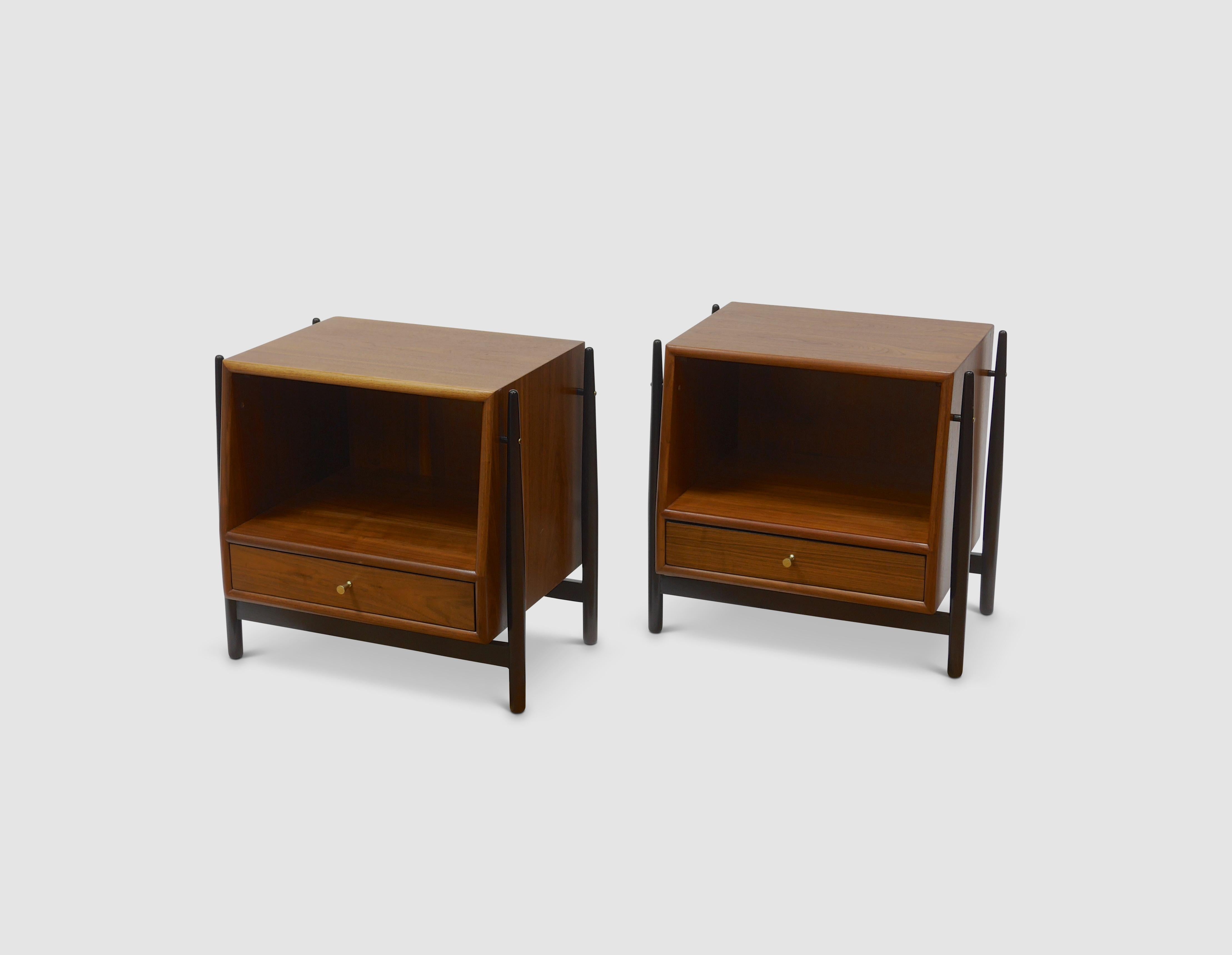 Nightstands in walnut by Kipp Stewart for Drexel. These nightstands have an exposed frame with a floating case piece. We borrowed the finish from Dunbar pieces of the period, the frames done in dark walnut, the cases left natural.