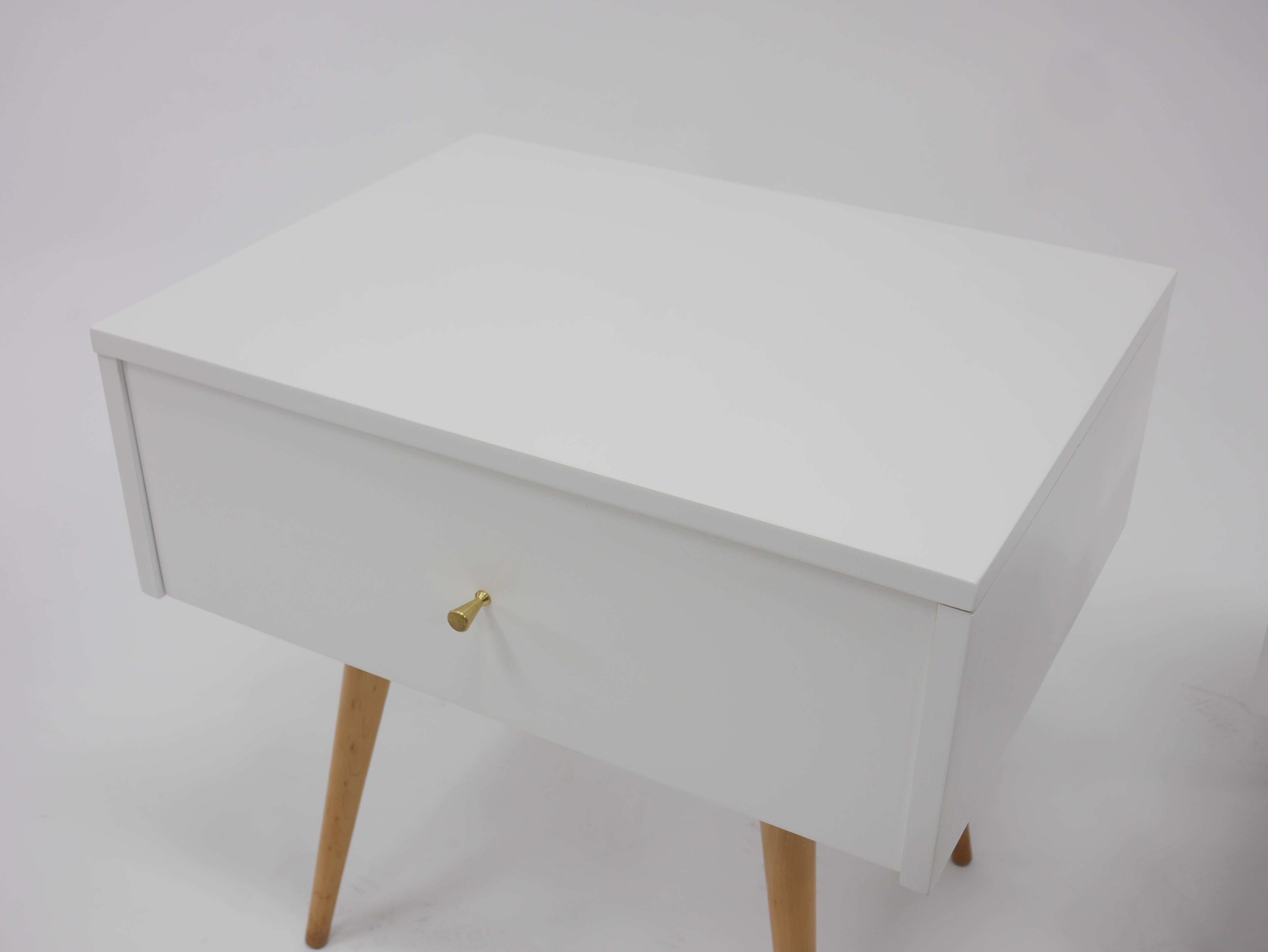 Nightstands in white lacquer by Paul McCobb for Planner Group, single drawer, brass hardware. Recent professional restoration.