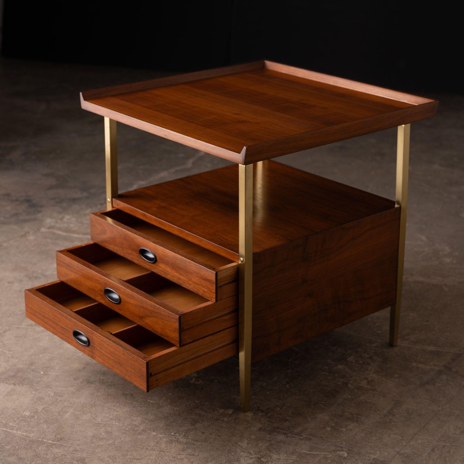 Pair of end tables / nightstands with three drawers designed by Milo Baughman for Arch Gordon. Constructed of walnut & solid brass, both tables have been professionally refinished and all of the solid brass legs have been removed, polished and