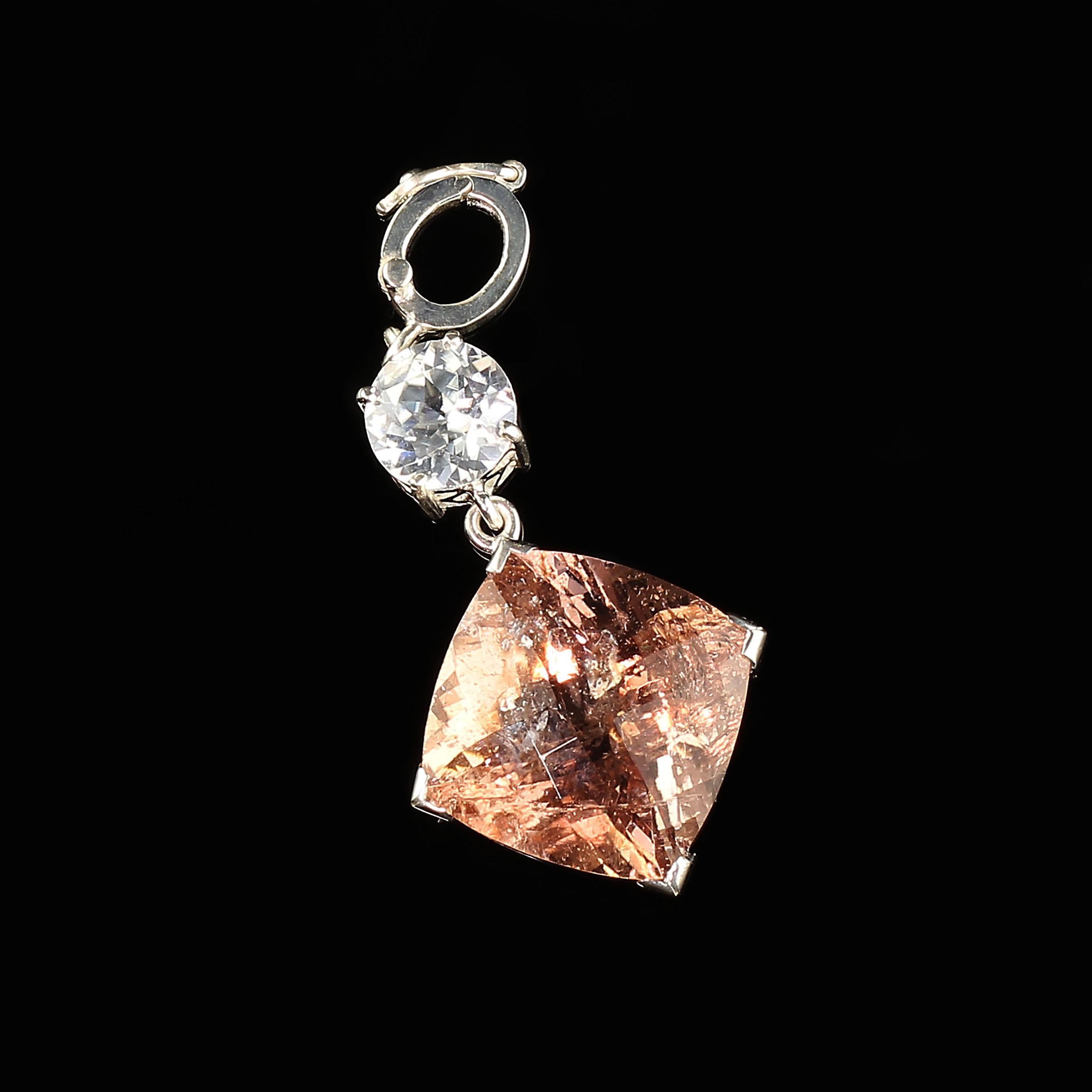 Elegant Evening wear Pendant from in a Morganite and genuineWhite Zircon.  This fabulous pendant hangs almost two inches from your favorite chain or pearls, nestling between pearls because of it's hinged opening. The Sterling Silver setting is hand