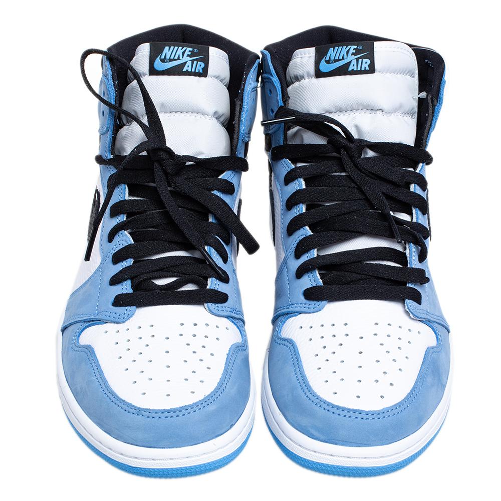 A white-black leather upper is laid with University Blue panels to form this Nike Jordan 1 University Blue Sneaker. Nike Air tag on the tongue, Swoosh in black, and Air Jordan Wings detail on the ankle inject the signature appeal. The sneakers are