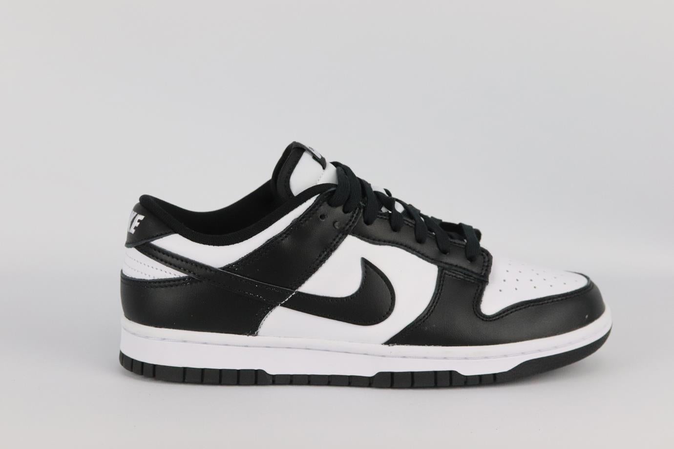Nike Dunk Low Retro leather sneakers. Black and white. Lace up fastening at front. Comes with box. Size: EU 41 (UK 7, US 8). Insole: 10.3 in. Heel: 1 in. Very good condition - Worn once. Light wear to soles; see pictures.