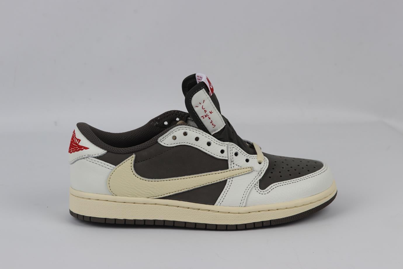 Nike + Travis Scott Air Jordan 1 low reverse mocha leather sneakers. Brown, white and cream. Lace up fastening at front. Comes with box and laces. Size: EU 38 (UK 5, US 5.5). Insole: 9.5 in. Heel Height: 0.8 in. New with box
