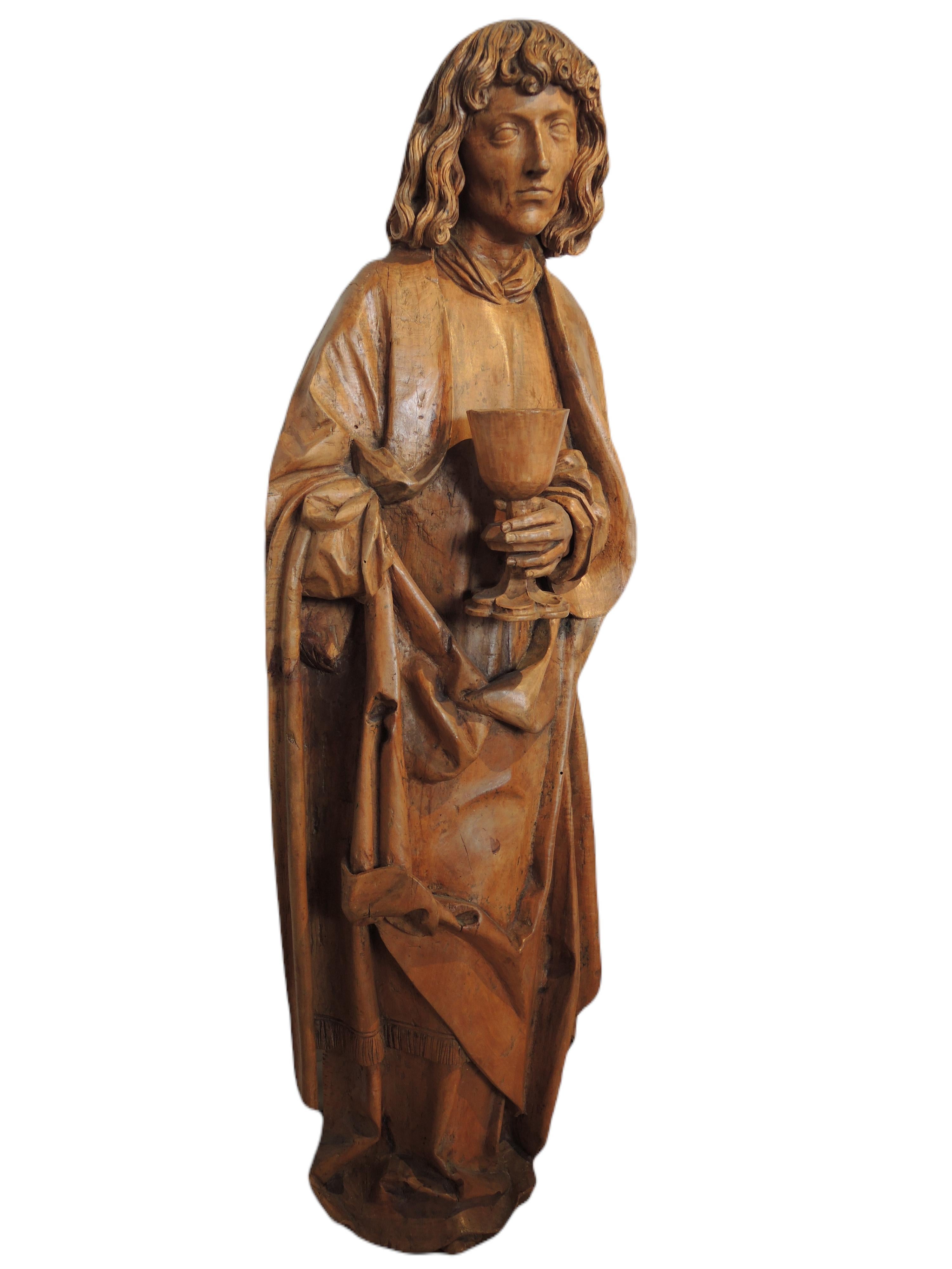 Large Saint John in sculpted linden, hollow back. South Germany, workshop of Niklaus Weckmann in Ulm towards the end of the 15th century. Our Saint John presents all the characteristics of the style of the master of Ulm: the expressive face with