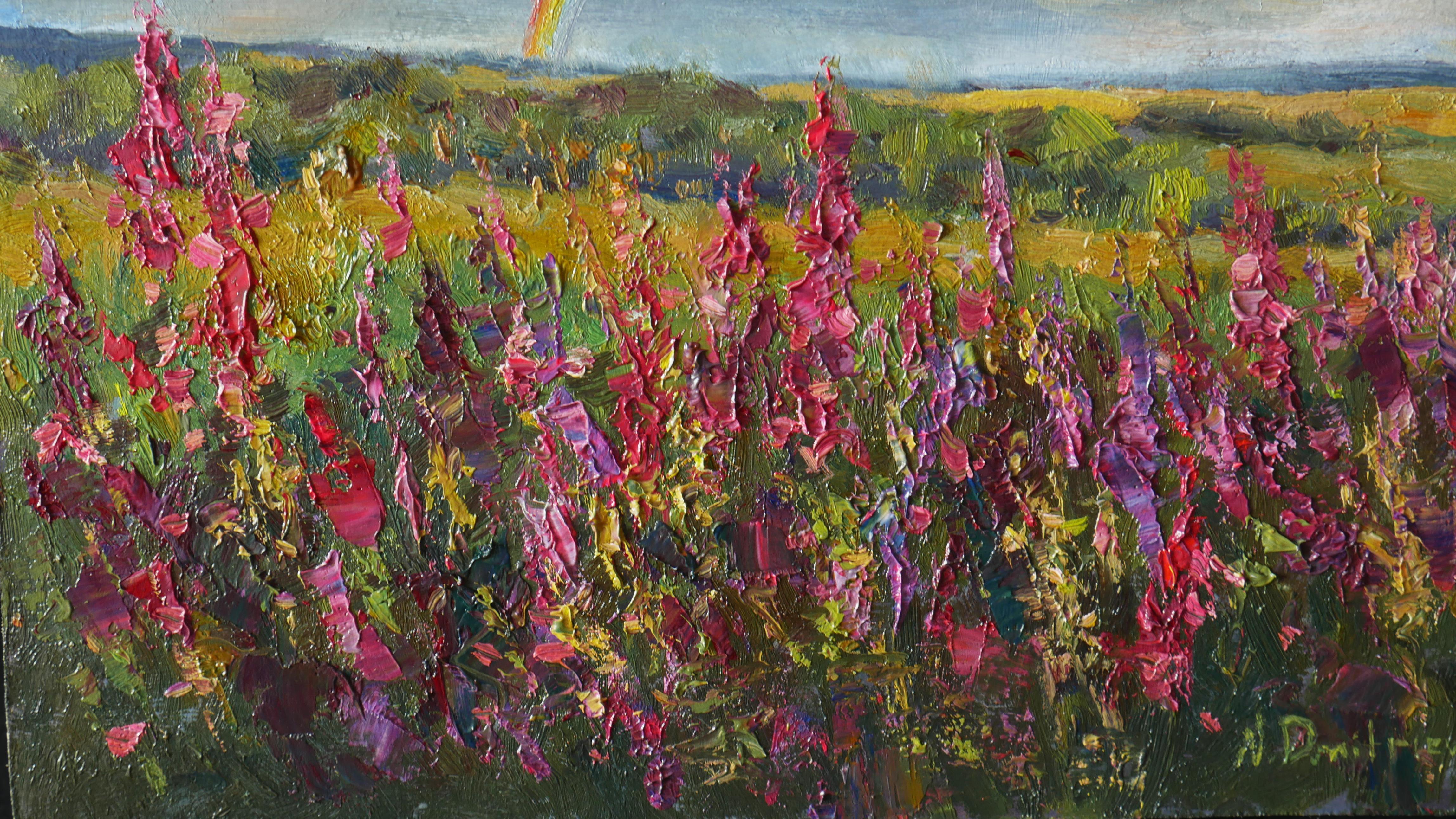 La luz dorada del sol se derramaba sobre los campos ondulados, donde el fireweed florecía en suaves ondas rosadas. Unas nubes ondulantes surcaban el cielo, y entre ellas se arqueaba un arco iris vibrante: un puente fugaz de la naturaleza entre la